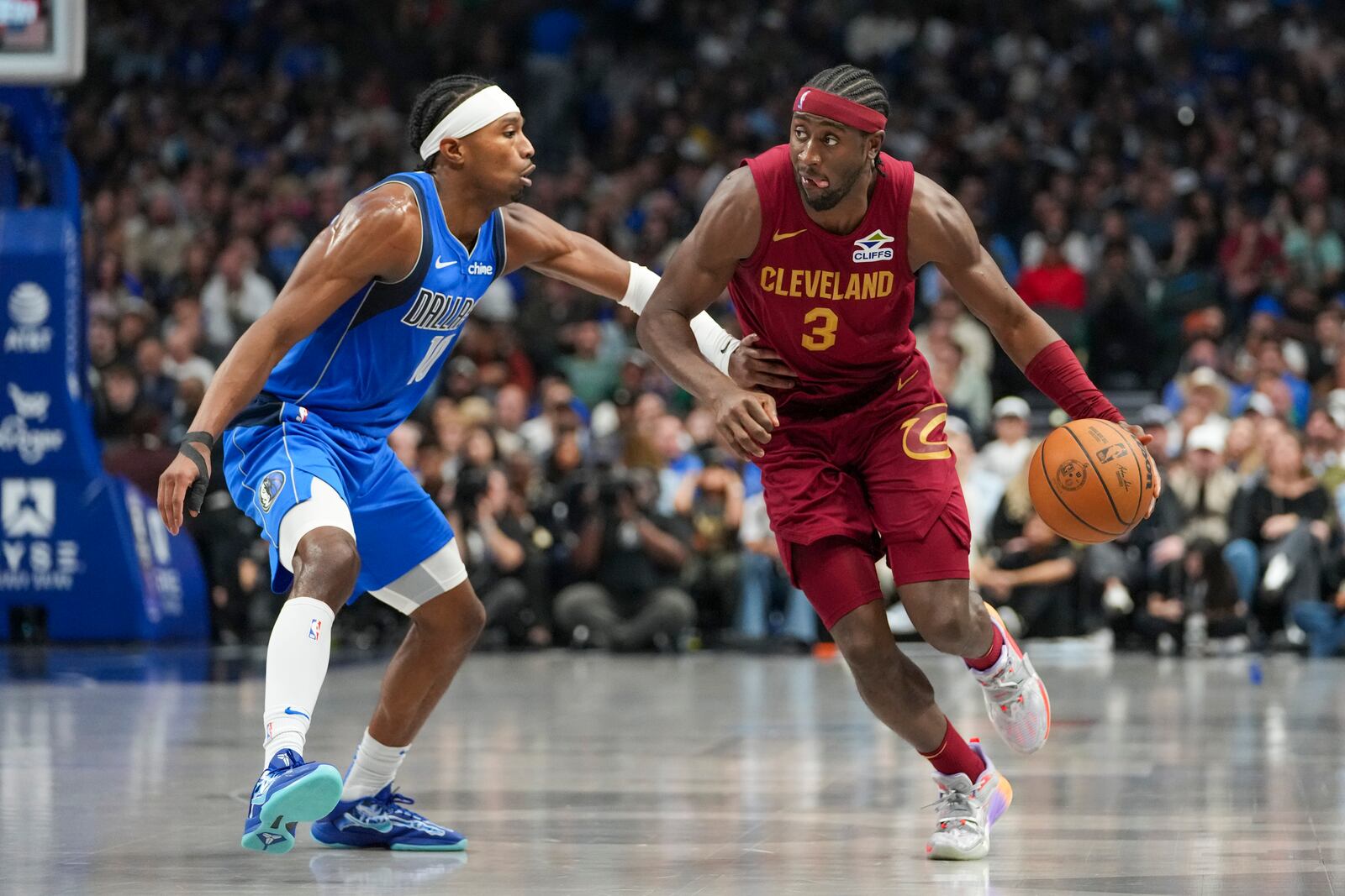 Cleveland Cavaliers guard Caris LeVert (3) drives against Dallas Mavericks guard Brandon Williams during the first half of an NBA basketball game, Friday, Jan. 3, 2025, in Dallas. (AP Photo/Julio Cortez)