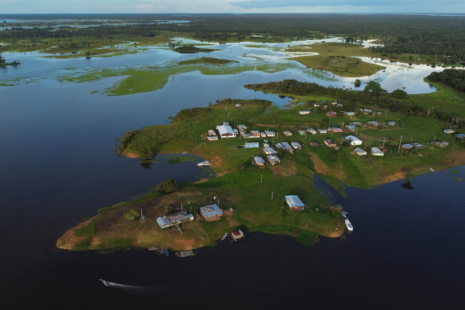 Homes are surrounded by water in the Lago do Soares village, in Autazes, Amazonas state, Brazil, Feb. 17, 2025. (AP Photo/Edmar Barros)