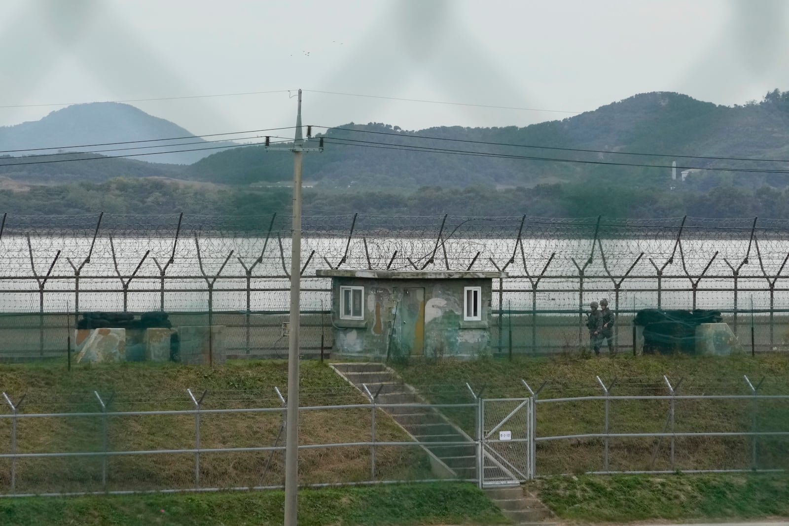 South Korean army soldiers patrol along the barbed-wire fence in Paju, South Korea, near the border with North Korea, Monday, Oct. 14, 2024. (AP Photo/Ahn Young-joon)