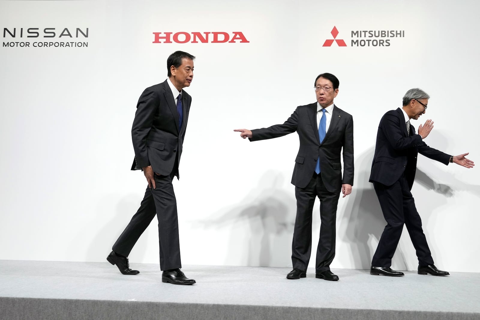 FILE - Nissan Chief Executive Makoto Uchida, left, Takao Kato, CEO of Mitsubishi Motors, center, and Honda Chief Executive Toshihiro Mibe, right, leave after a joint news conference in Tokyo, Japan, Dec. 23, 2024. (AP Photo/Eugene Hoshiko, File)