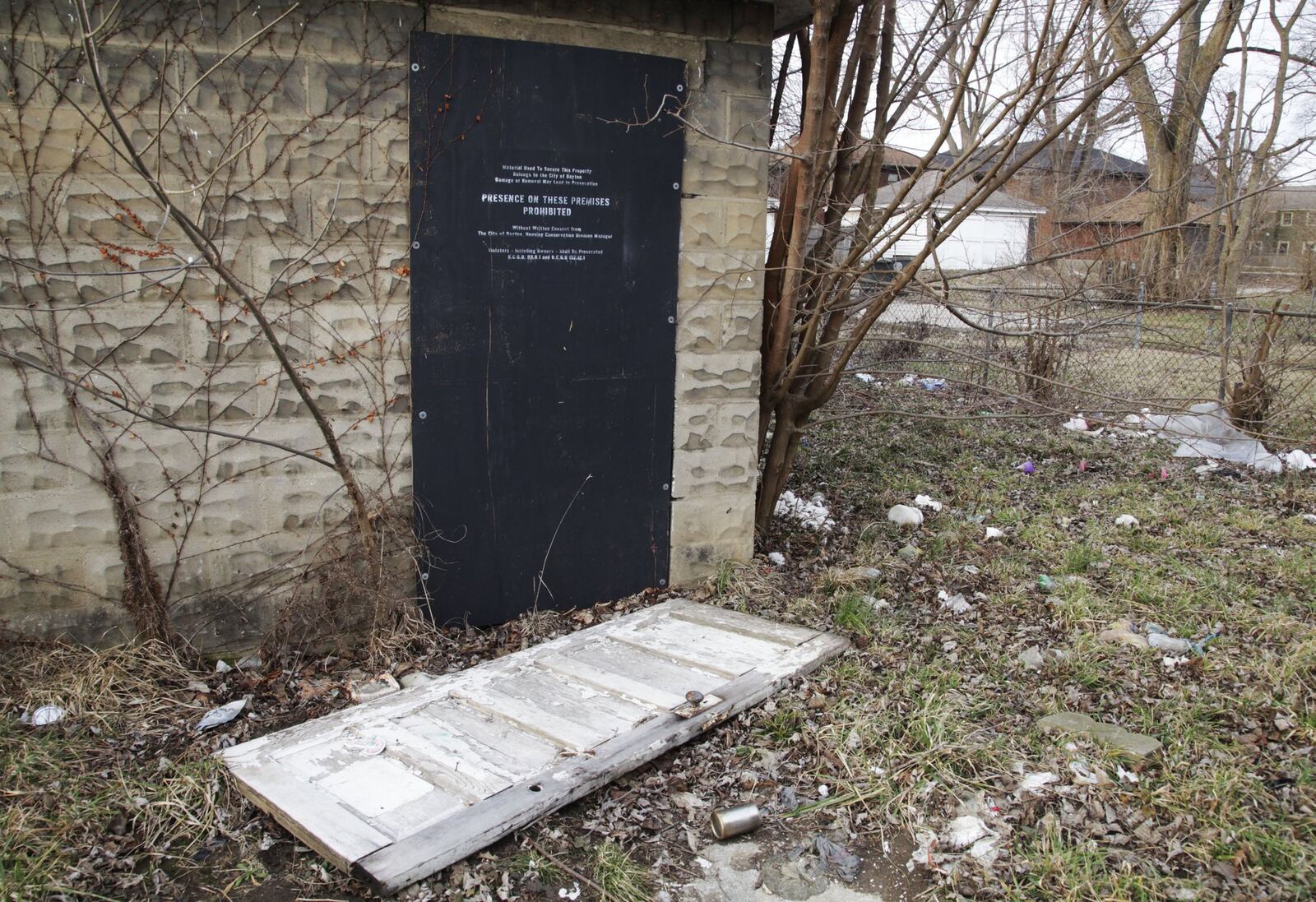 The body of Deanna Prendergast was found on the ground under a door in the back yard near this detached garage of the duplex at 15-17 E. Hudson Ave. in Dayton on Sept. 15, 2017. BYRON STIRSMAN/STAFF