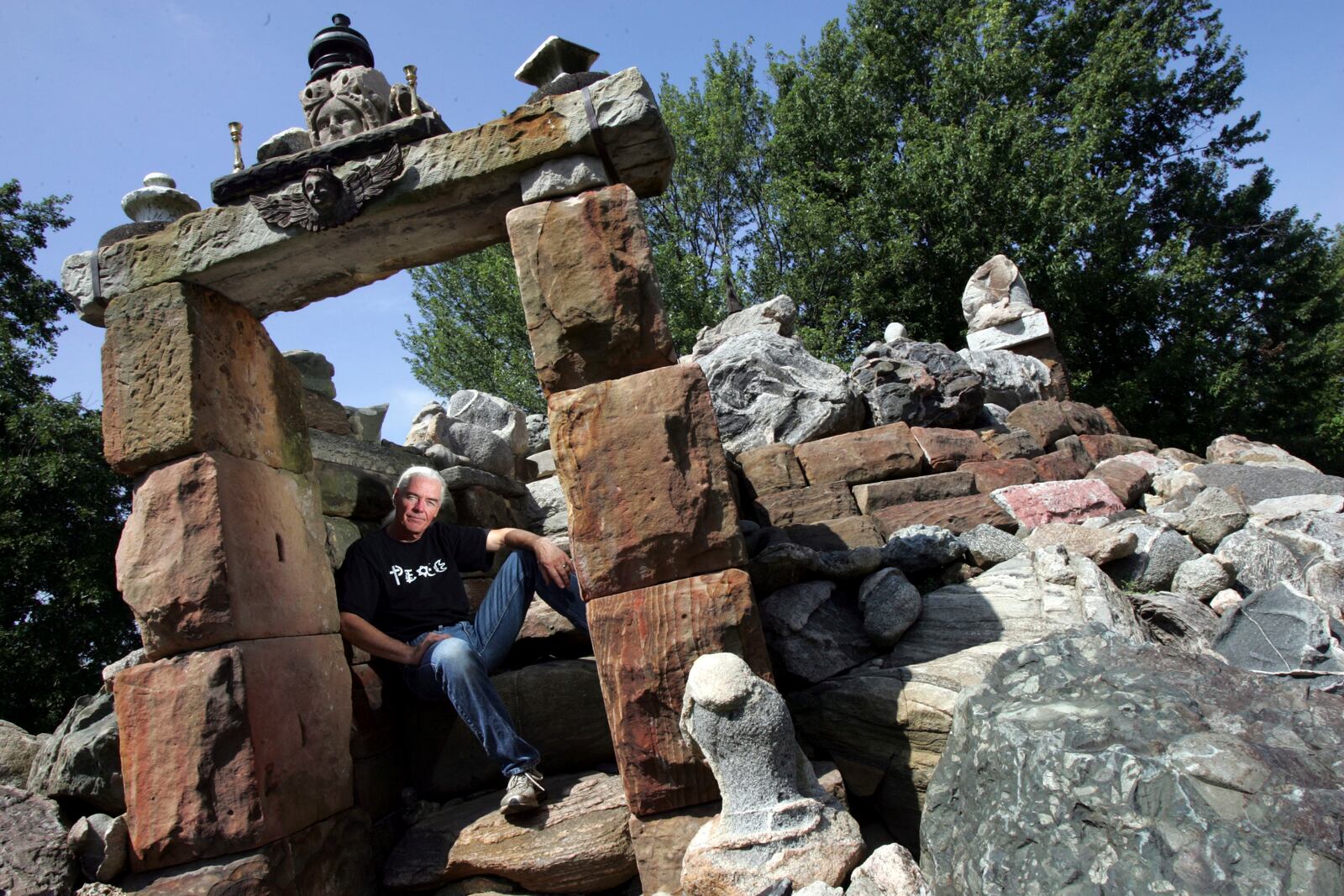 Jim Bowsher sits in his Garden of Tolerance  in his backyard at Wapakoneta, Ohio. (Columbus Dispatch, Eric Albrecht)