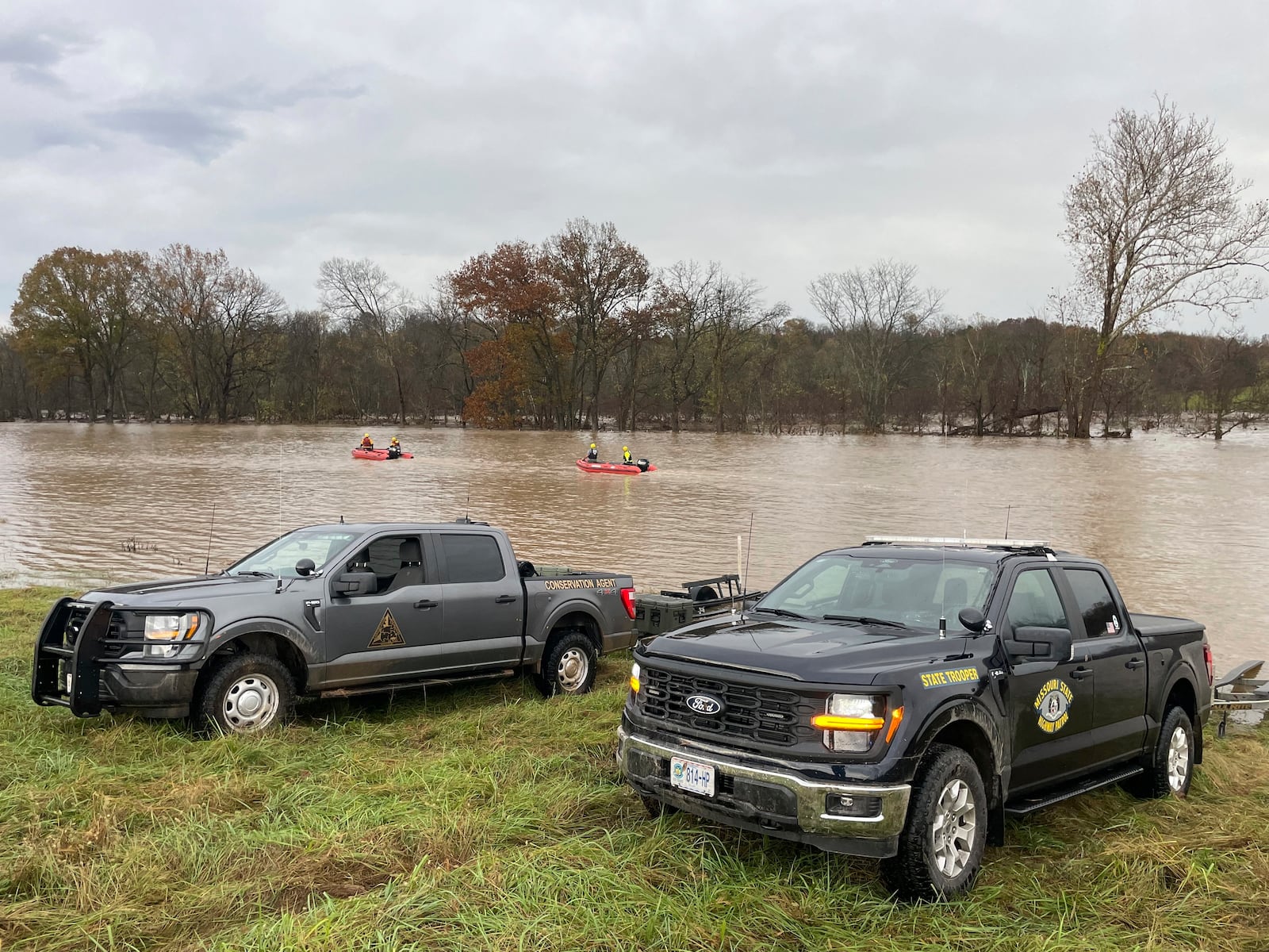 In a photo released by the Missouri State Highway Patrol, patrol vehicles and rescue boats are from rescue efforts on a swollen river in Manes Mo., Tuesday, Nov. 5, 2024. (Missouri State Highway Patrol via AP)