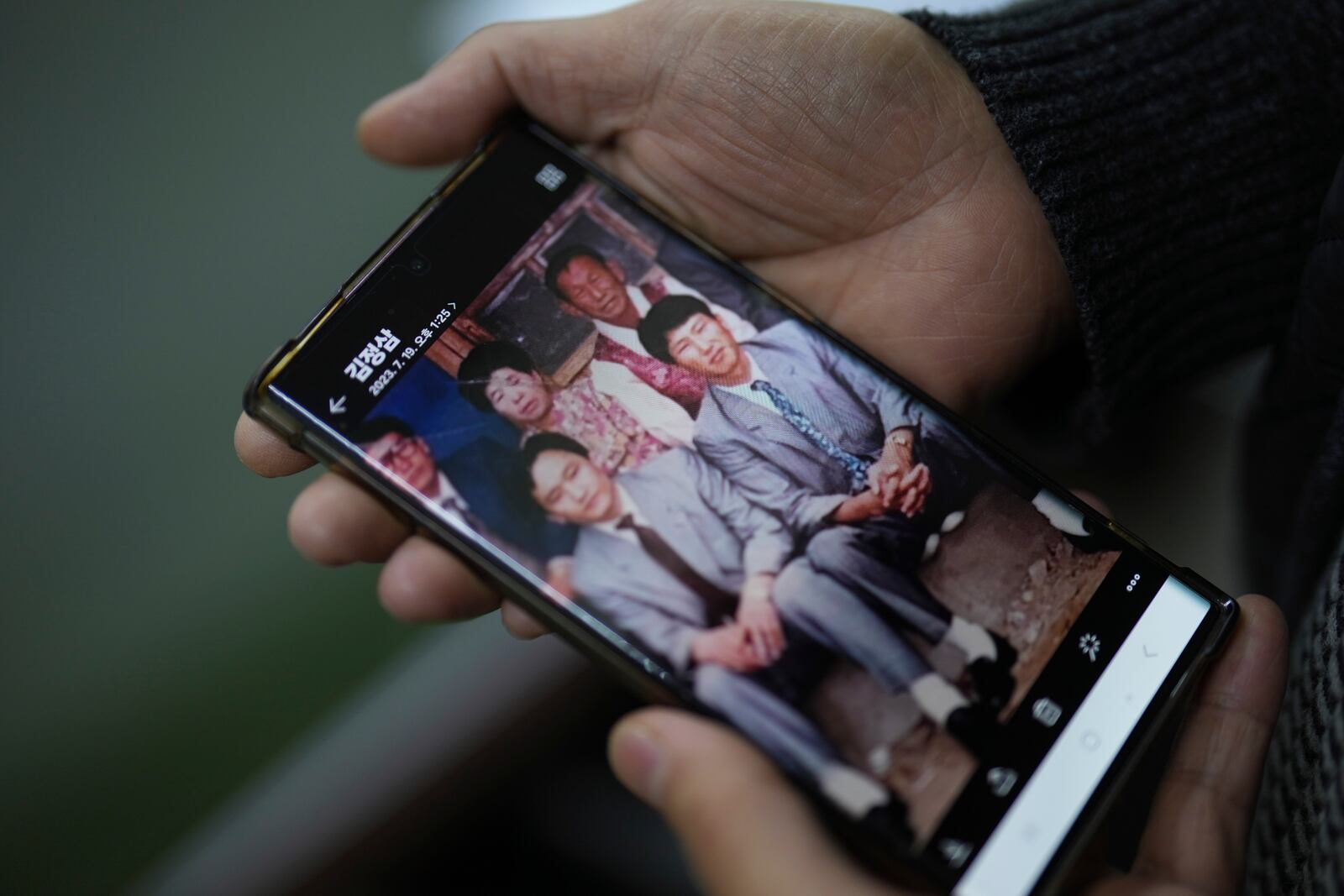 Kim Jeong-sam, brother of missionary Kim Jung Wook, shows his brother Kim Jung Wook's photo, bottom right, at his office in Incheon, South Korea, Nov. 29, 2024. (AP Photo/Lee Jin-man)