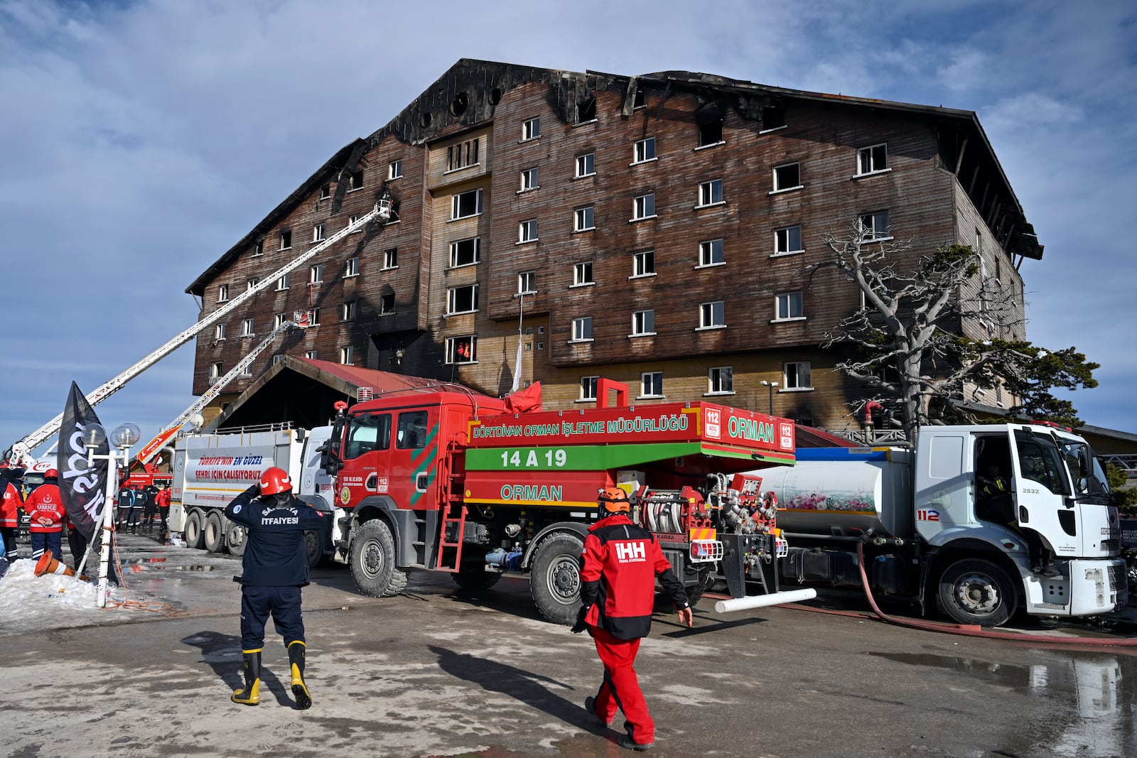 Firefighters workat the scene after a fire broke out at a hotel in the ski resort of Kartalkaya, located in Bolu province, northwest Turkey, on Tuesday, Jan. 21, 2025. (Mert Gokhan Koc/DIA Photo via AP)