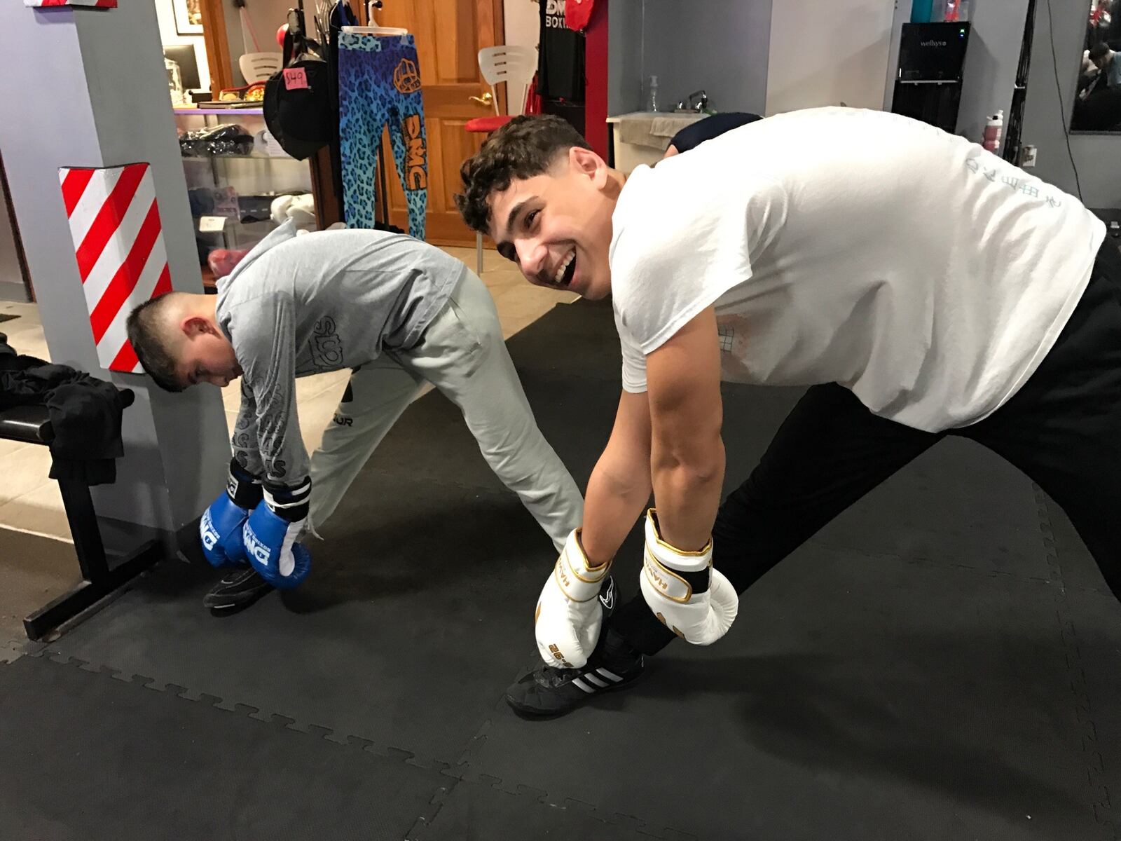 Aydin Idrisov and Ravshan Akhmabov do stretching exercises during a training session at Daniel Meza-Cuadra’s DMC Boxing Academy in Centerville.  Akhmabov, a junior at Springboro High and Idrisov, a fourth grader at Bethel Grade School – both Turkish boxers – will take part in a 13-bout exhibition show to benefit Turkish earthquake victims this Sunday at 2p.m. at the Ahiska Turkish American Community Center, 1306 E. Fifth Street. Tom Archdeacon/CONTRIBUTED