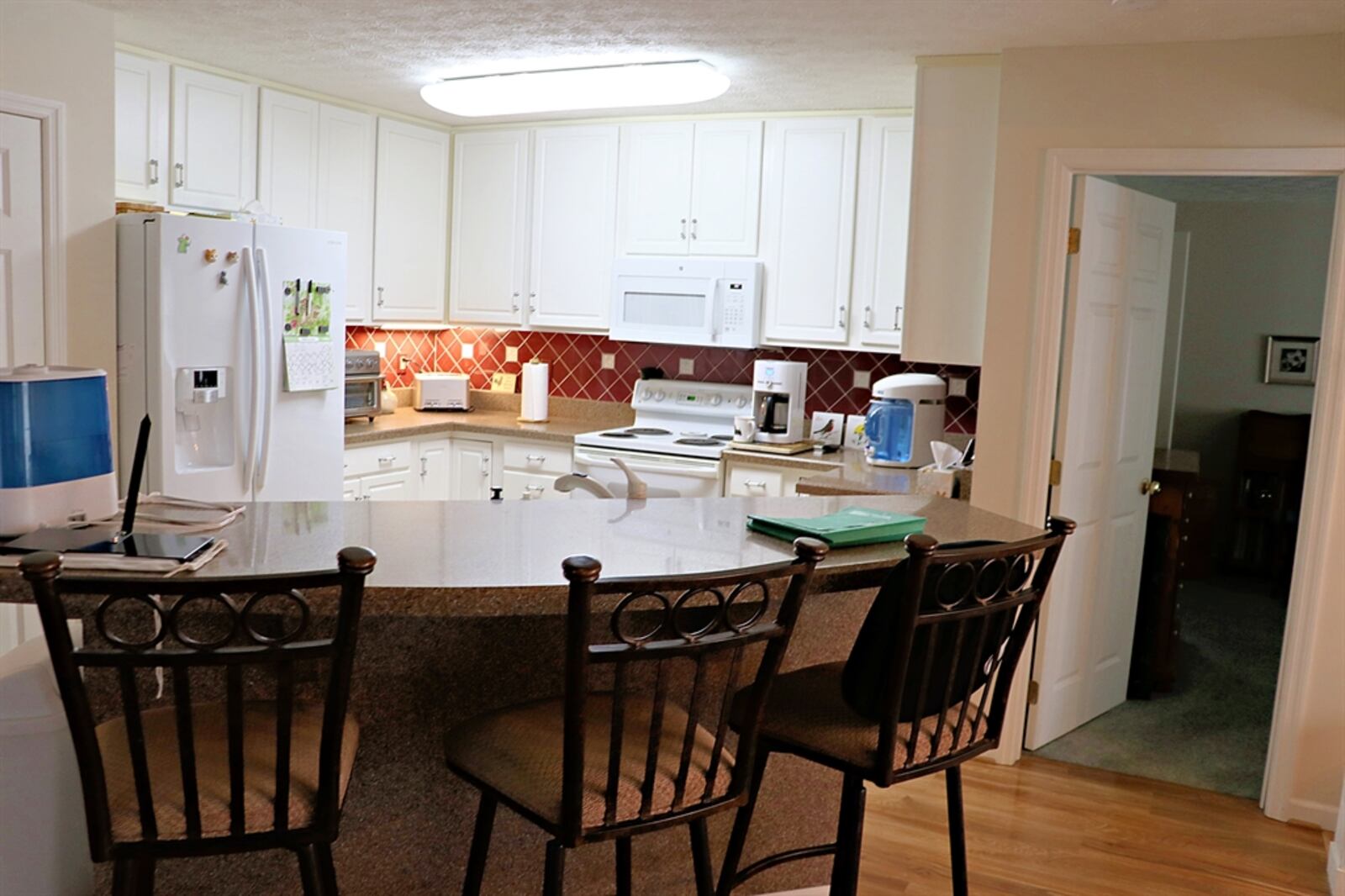 A dual-counter island divides the kitchen from the great room. The elevated counter offers bar seating and the bar seats are included.