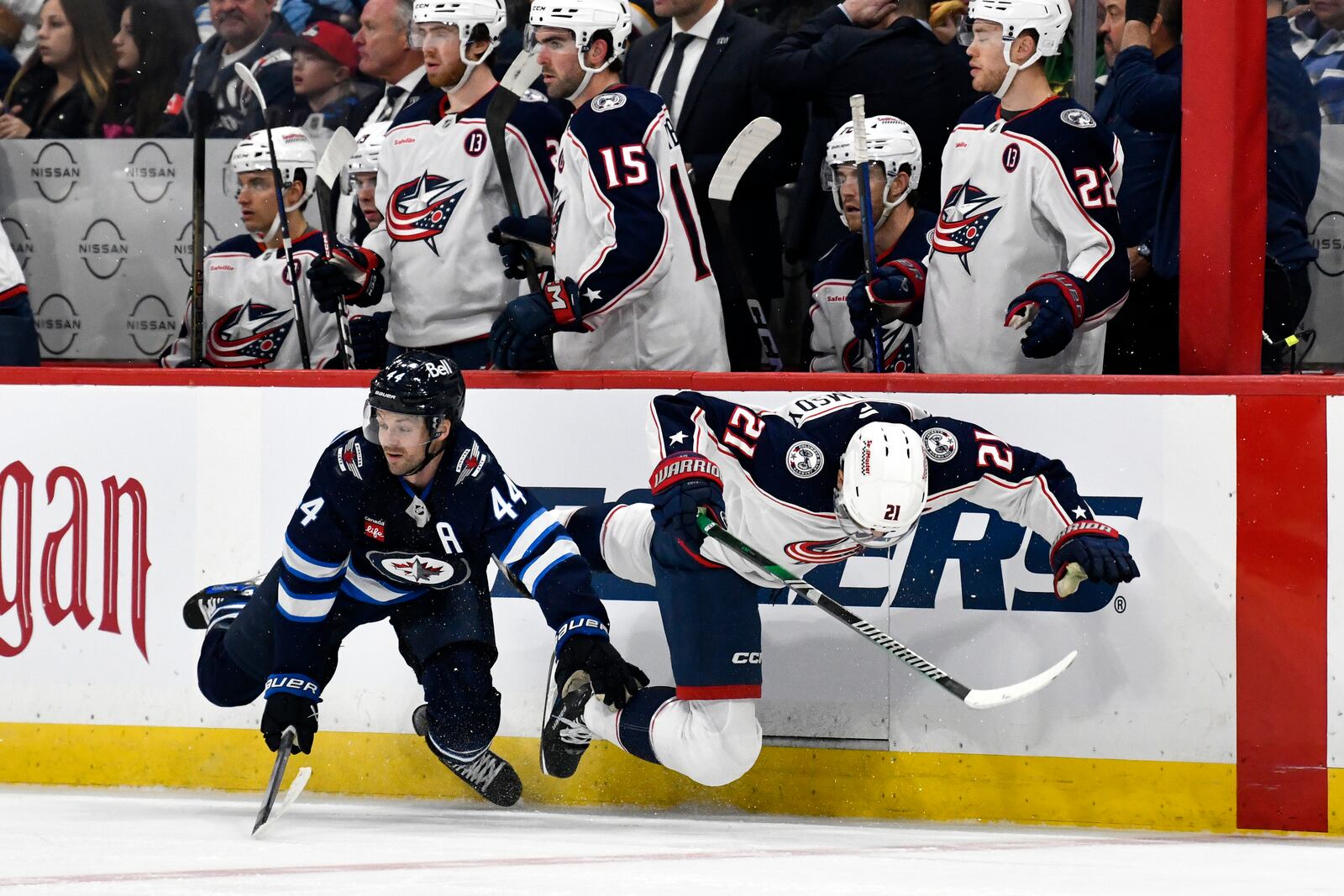 Columbus Blue Jackets' James van Riemsdyk (21) collides with Winnipeg Jets' Josh Morrissey (44) during the second period of an NHL hockey game in Winnipeg, Canada Sunday, Dec. 8, 2024. (Fred Greenslade/The Canadian Press via AP)