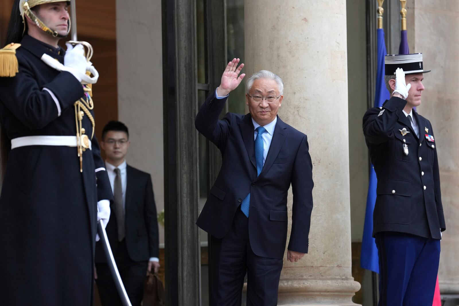 China's Vice Premier Zhang Guoqing, center, waves from the steps of the Elysee Palace during events on the sidelines of an Artificial Intelligence Action Summit in Paris, Monday, Feb. 10, 2025. (AP Photo/Aurelien Morissard)