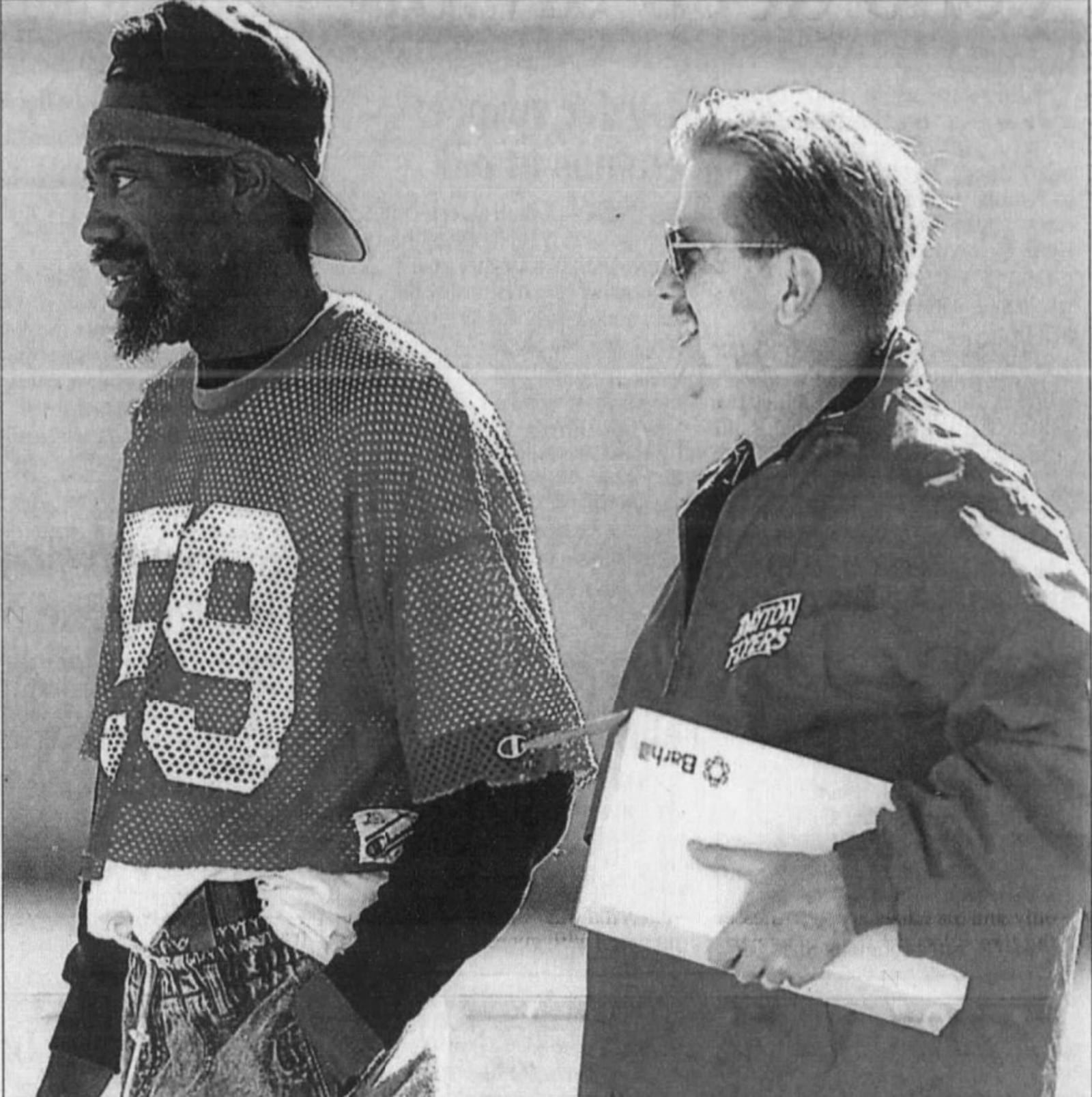 Andre Owings, left, stands with University of Dayton Athletic Director Ted Kissell during a game at Welcome Stadium in 2000. Dayton Daily News photo