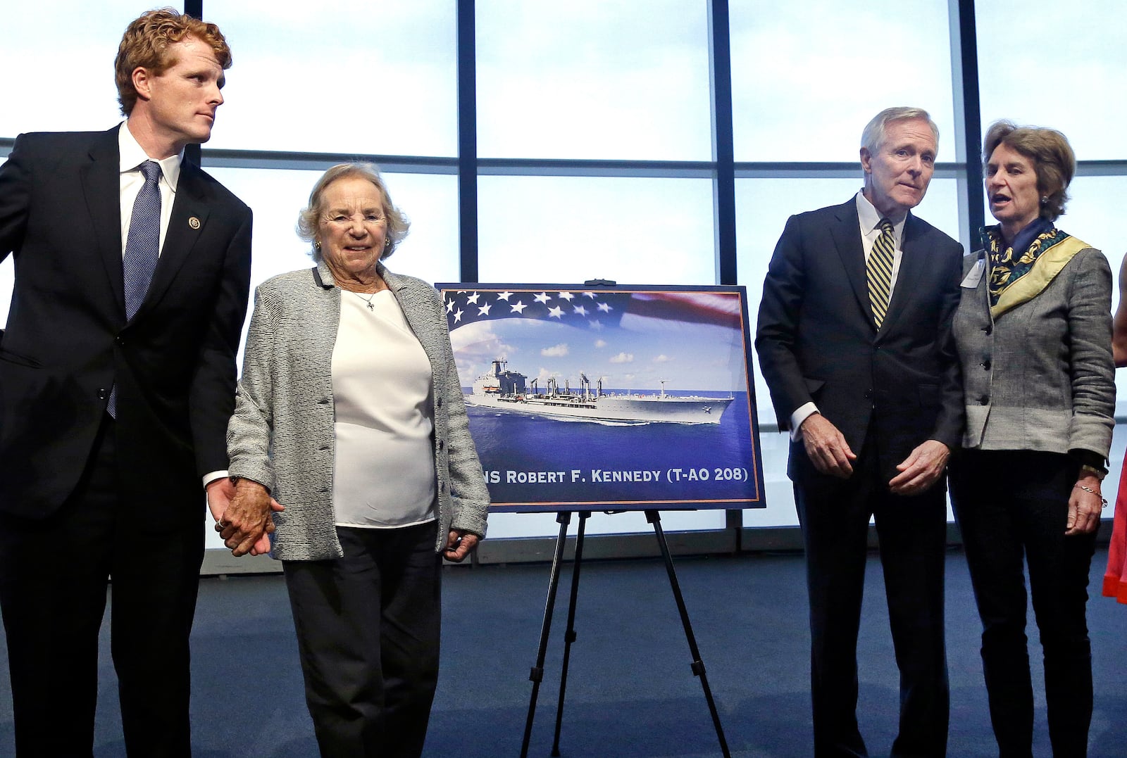 FILE - Ethel Kennedy holds hands with grandson Joseph P. Kennedy III, left, while Navy Secretary Ray Mabus chats with her daughter Kathleen Kennedy Townsend, as they pose near a rendering of the Robert F. Kennedy Navy Ship named at the John F. Kennedy Presidential Library, Tuesday, Sept. 20, 2016, in Boston. (AP Photo/Elise Amendola, File)