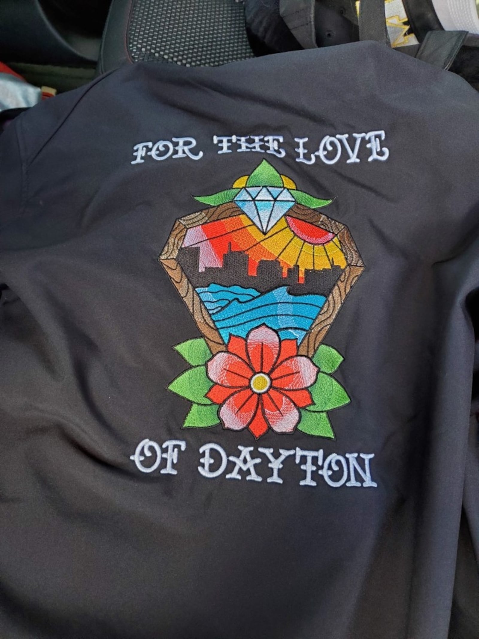 The back of the jacket — proclaiming 'For the Love of Dayton' — that Jeremy Ganger was given when he was honored at a fundraising event at the Antioch Shrine in Dayton to raise funds for the shooting victims. Contributed photo.