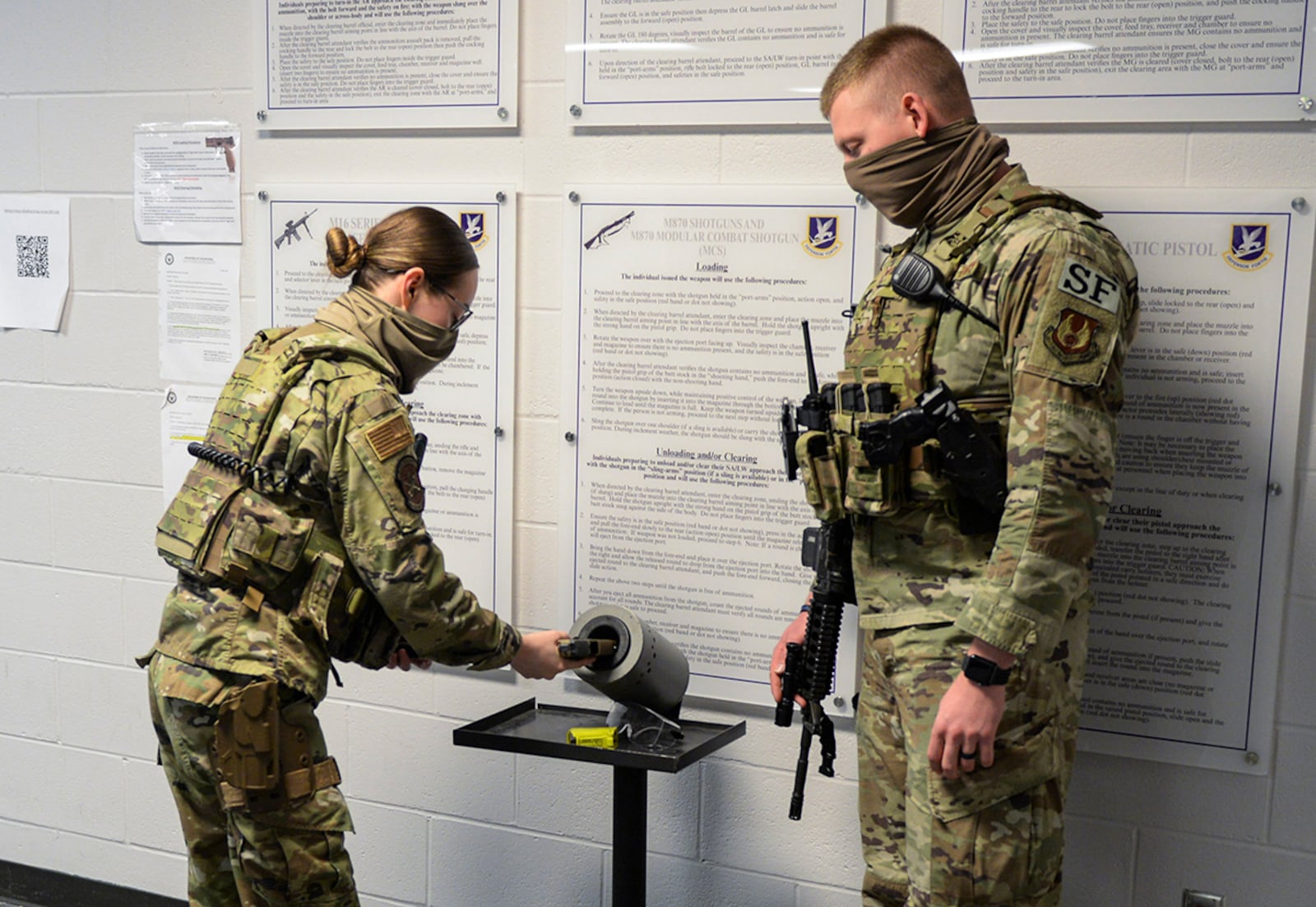 Airman 1st Class Iliana Arroyo, 88th Security Forces Squadron patrolman, loads a magazine into her M9 handgun alongside Senior Airman Kyle Brown, a Base Defense Operations Center controller, on March 16 at Wright-Patterson Air Force Base. U.S. AIR FORCE PHOTO/WESLEY FARNSWORTH