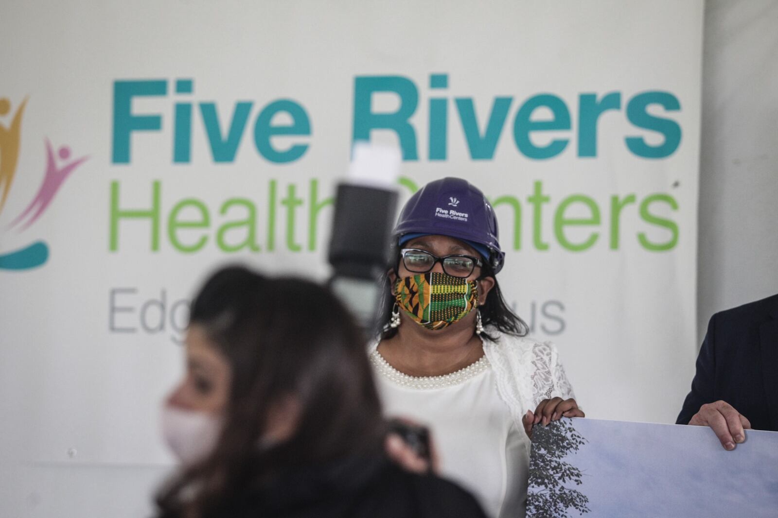 Five Rivers Health Centers C.E.O. Gina McFarlane-El talks to groundbreaking attendees Wednesday morning. Five Rivers Health Centers is building a new Edgemont Campus on Miami Chapel Rd. in Dayton. JIM NOELKER/STAFF