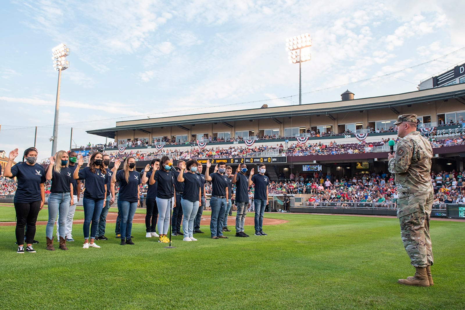 Col. Patrick Miller, 88th Air Base Wing and Wright-Patterson Air Force Base commander, administers the oath of enlistment to 17 individuals in the Delayed Entry Program prior to a Dayton Dragons game at Day Air  Ballpark. The event was part of a Hometown Heroes event at the park.  U.S. AIR FORCE PHOTO/WESLEY FARNSWORTH