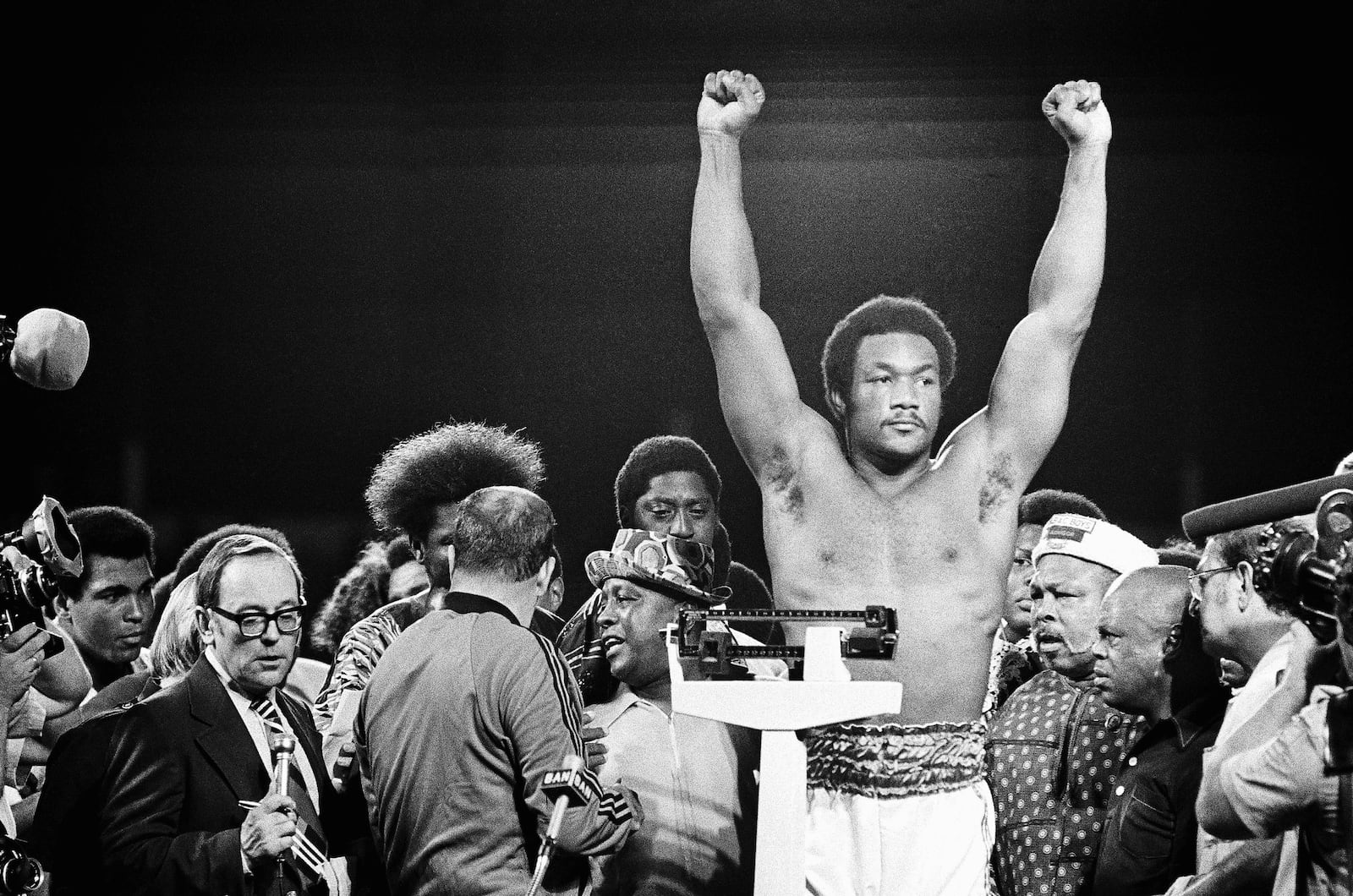 FILE - Heavyweight champion George Foreman responds to cheers of crowd in stadium in Kinshasa, Zaire Saturday night, October 26, 1974 during the weigh in for his title defense against Muhammad Ali. (AP Photo, File)