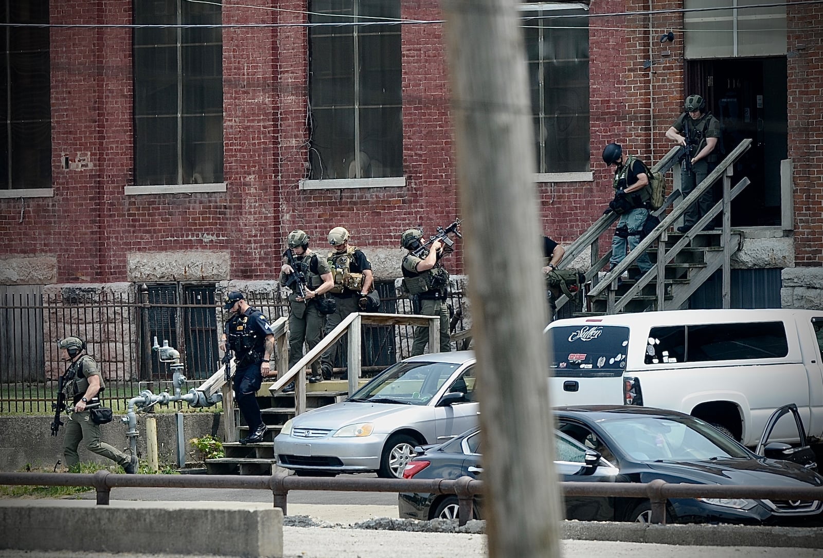 Members of the SWAT team exit the Davis Linden building. MARSHALL GORBY/STAFF