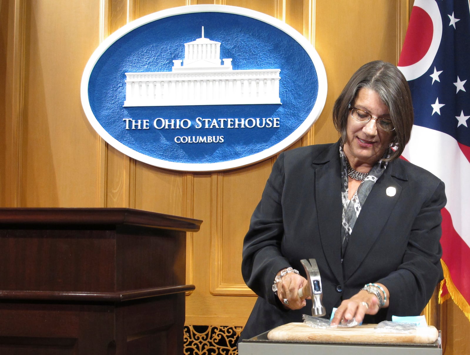 FILE - In this Sept. 17, 2015, file photo, Ohio state Rep. Nickie Antonio, a Democrat from Lakewood in suburban Cleveland, demonstrates tamper-resistant pain pills during a news conference in Columbus, Ohio. Ohio death penalty opponents are announcing a new effort to end capital punishment that includes several GOP supporters of a ban. Antonio, a longtime death penalty opponent, was joined at a news conference Thursday, Feb. 18, 2021, by three Republican senators who support ending capital punishment.  (AP Photo/Andrew Welsh-Huggins, File)