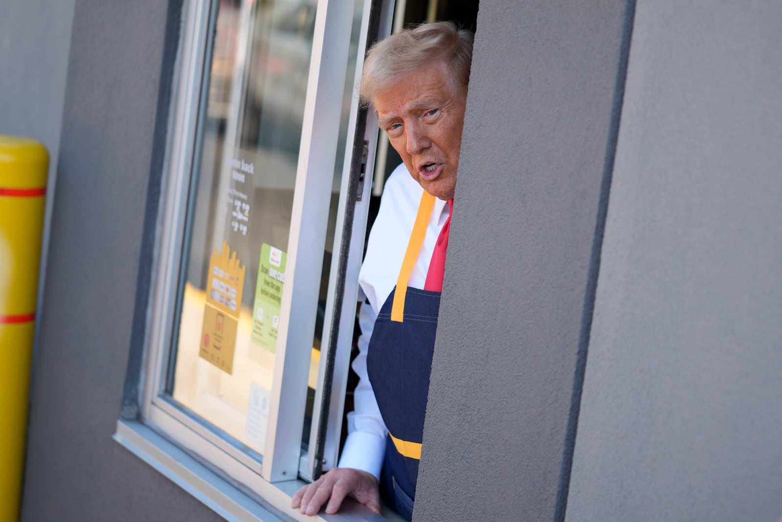 Republican presidential nominee former President Donald Trump speaks from a drive-thru window during a campaign stop at a McDonald's, Sunday, Oct. 20, 2024, in Feasterville-Trevose, Pa. (AP Photo/Evan Vucci)