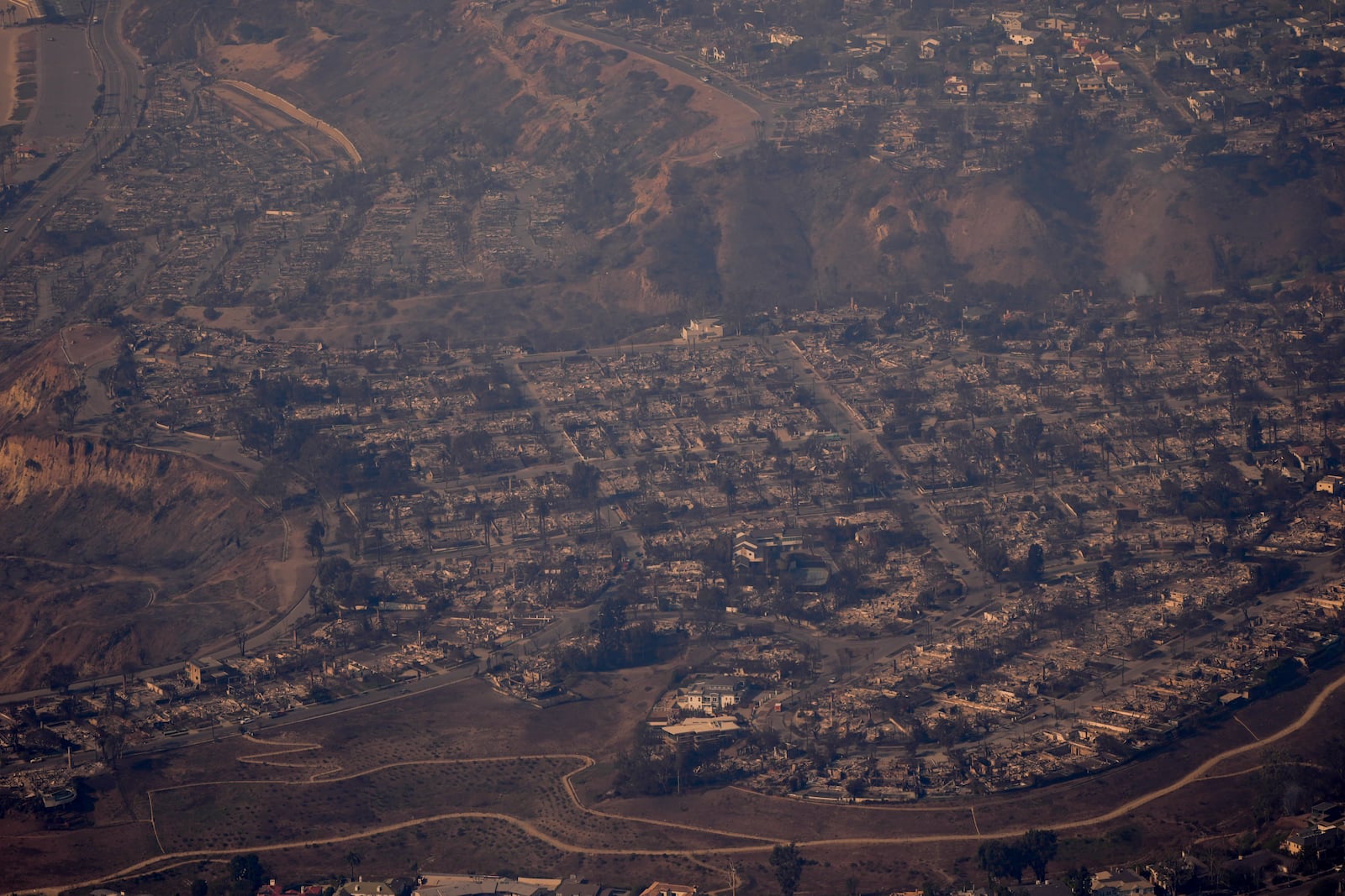 The devastation from the Palisades Fire is seen from the air in the Pacific Palisades neighborhood of Los Angeles, Thursday, Jan. 9, 2025. (AP Photo/Mark J. Terrill)