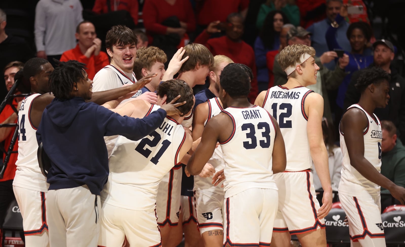 Dayton celebrates after a 3-pointer by Atticus Schuler in the final minutes against Oakland on Wednesday, Dec. 20, 2023, at UD Arena. David Jablonski/Staff