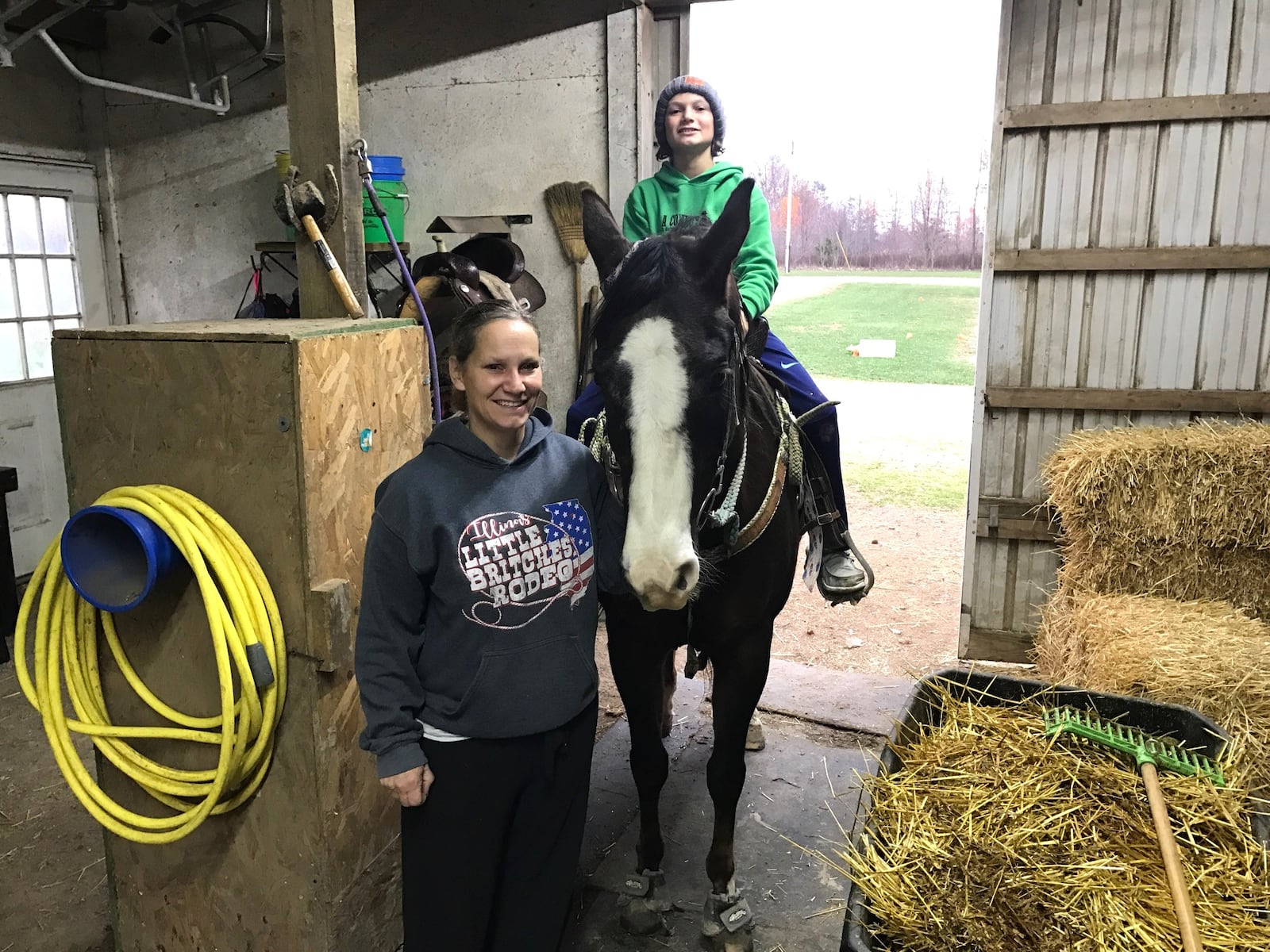 Emily Hays with her 11-year -old son Colton, who’s aboard Kate, his barrel riding horse, at their barn just west of Celina. Emily has been a harness racing driver and trainer while also working a third shift factory job. Tom Archdeacon/CONTRIBUTED