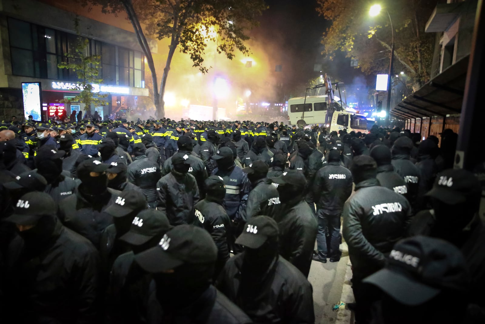 Police gather to push protesters away from a street during a rally against the results of the parliamentary elections amid allegations that the vote was rigged in Tbilisi, Georgia, on Tuesday, Nov. 19, 2024. (AP Photo/Zurab Tsertsvadze)