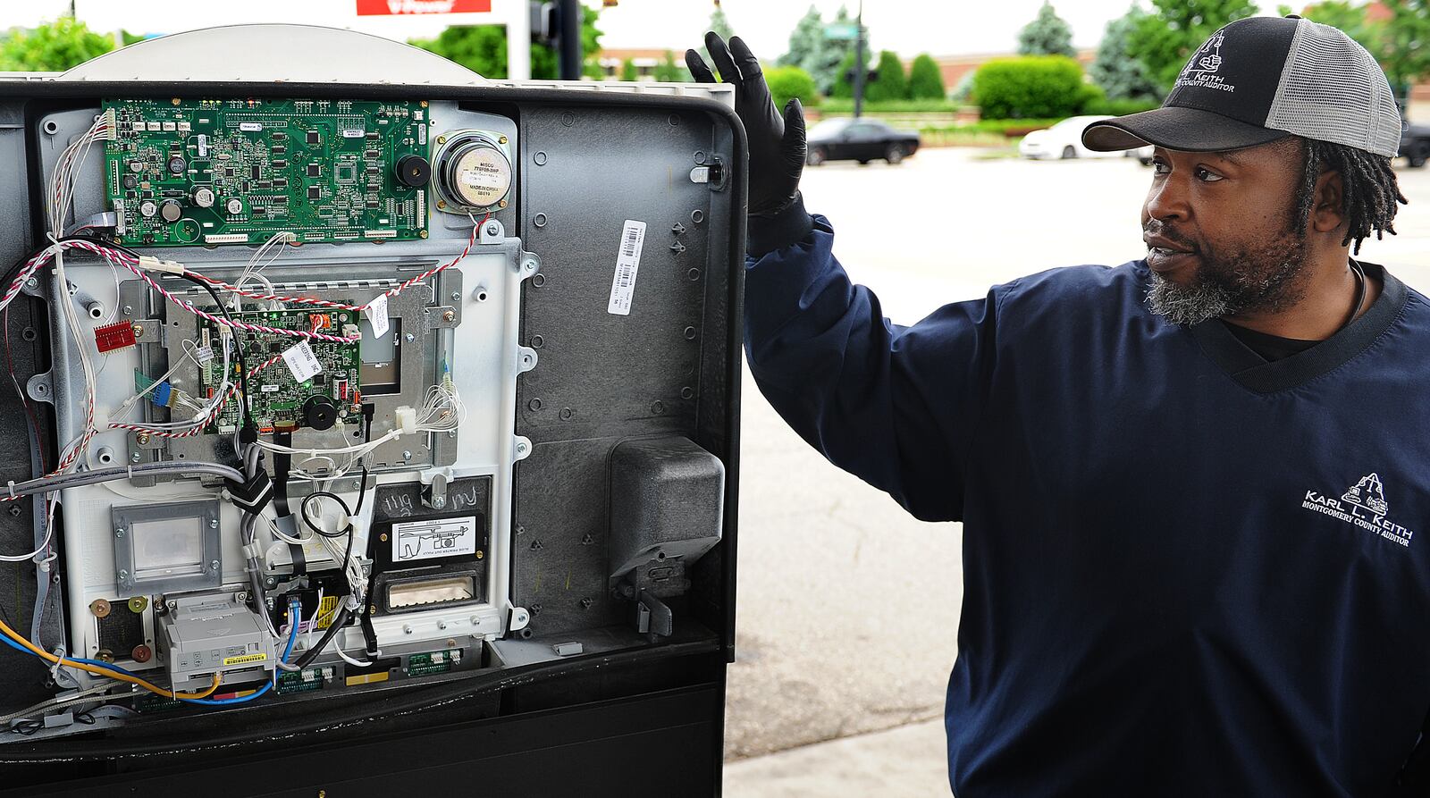 Joseph Harris, chief inspector with the Montgomery County Auditor's Office, shows the inside of a gas pump Wednesday, May 25, 2022 and how criminals hide credit card skimmers inside. MARSHALL GORBY\STAFF