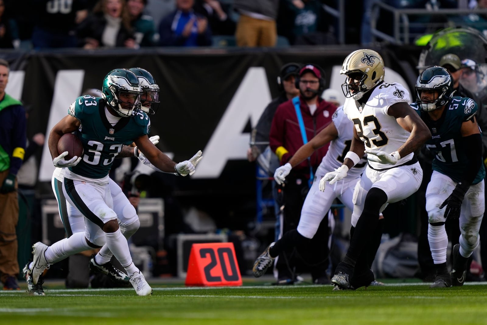 Philadelphia Eagles cornerback Josiah Scott (33) returns an interception past New Orleans Saints tight end Juwan Johnson (83) in the first half of an NFL football game in Philadelphia, Sunday, Jan. 1, 2023. (AP Photo/Matt Rourke)