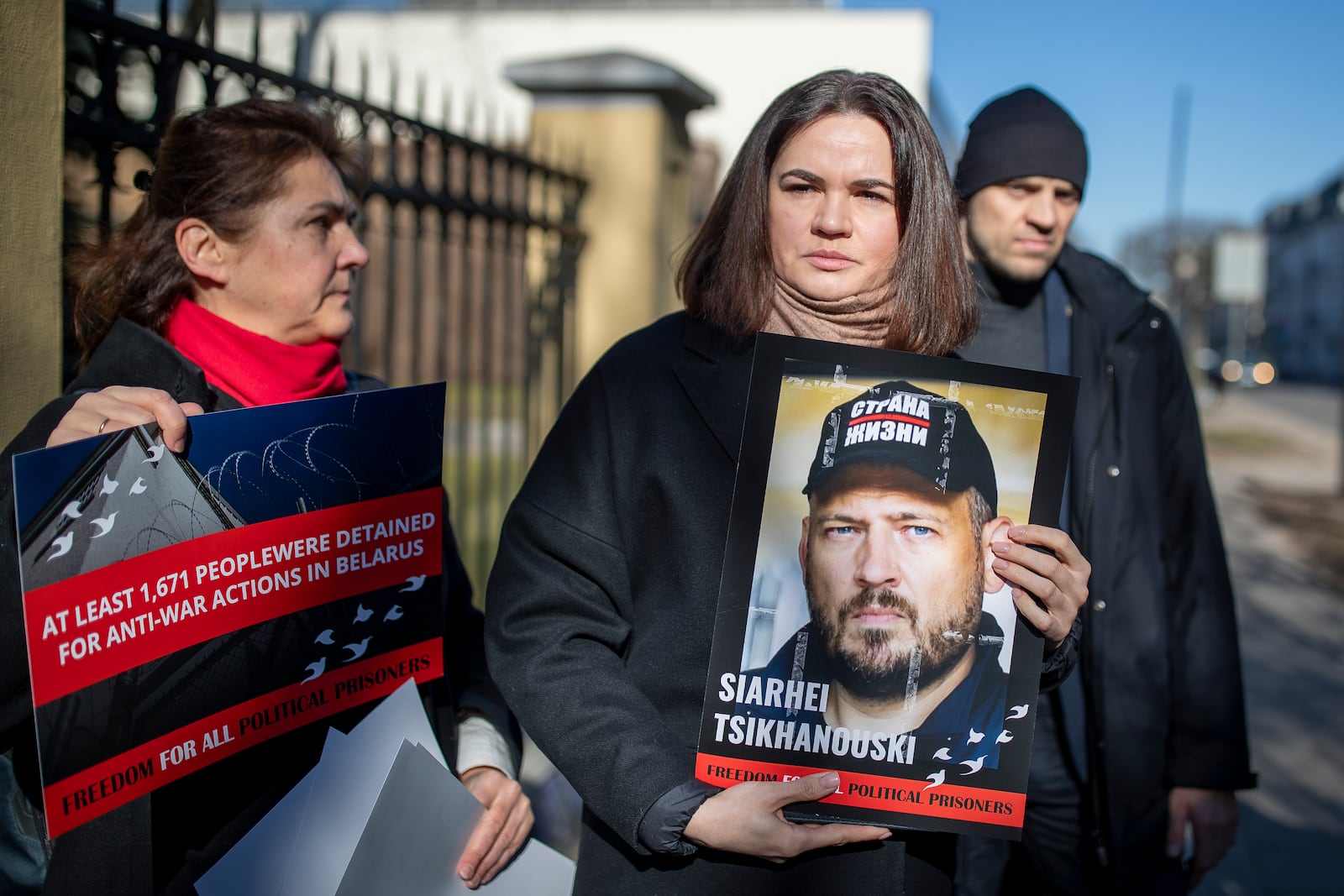 FILE - Belarusian opposition leader Sviatlana Tsikhanouskaya holds a portrait of her jailed husband, Siarhei Tsikhanouski, during a protest demanding freedom for political prisoners, outside the Belarus embassy in Vilnius, Lithuania, March 8, 2024. (AP Photo/Mindaugas Kulbis, File)