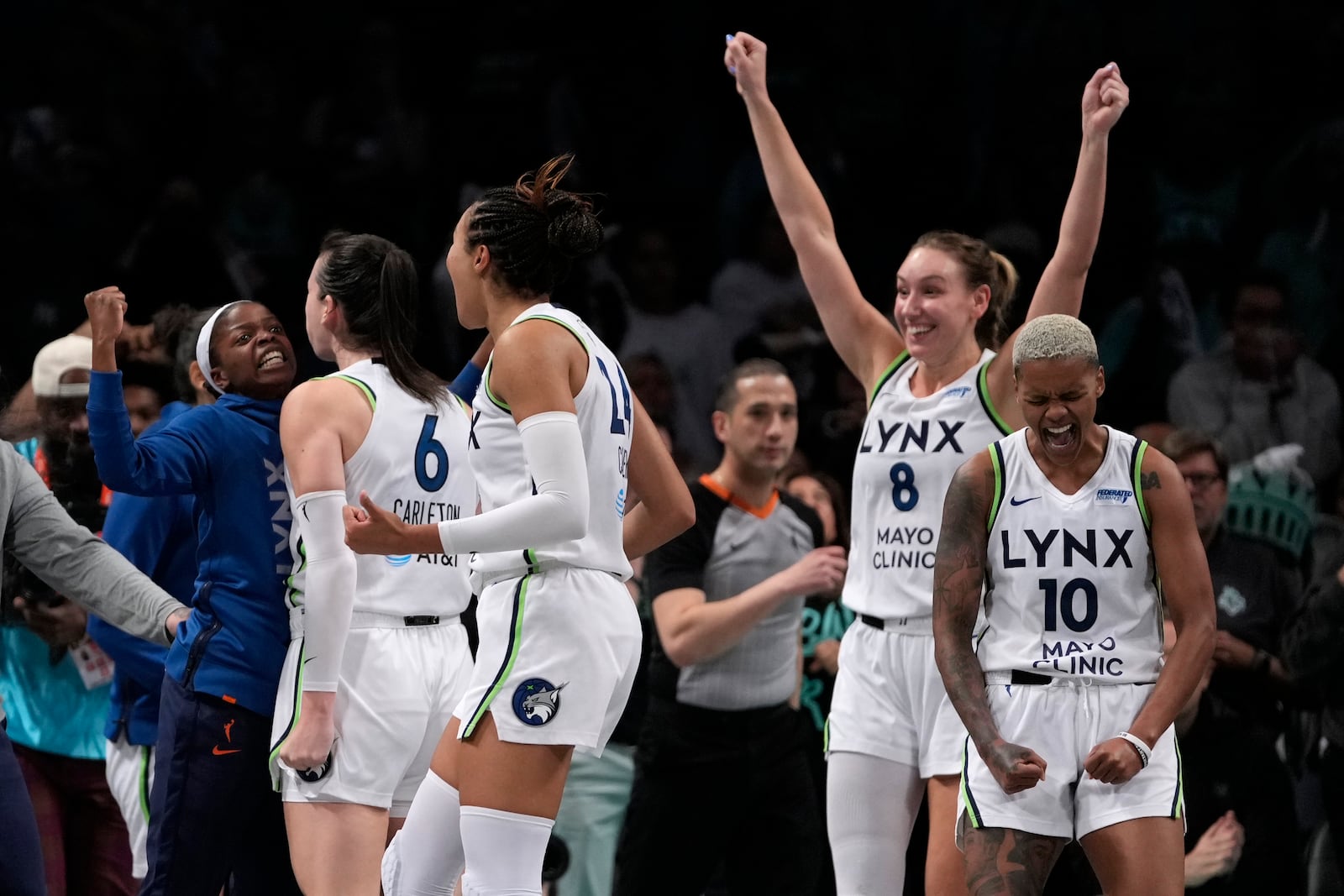 From left, Minnesota Lynx's Bridget Carleton, Napheesa Collier, Alanna Smith and Courtney Williams celebrate after defeating the New York Liberty in overtime in Game 1 of a WNBA basketball final playoff series, Thursday, Oct. 10, 2024, in New York. (AP Photo/Pamela Smith)