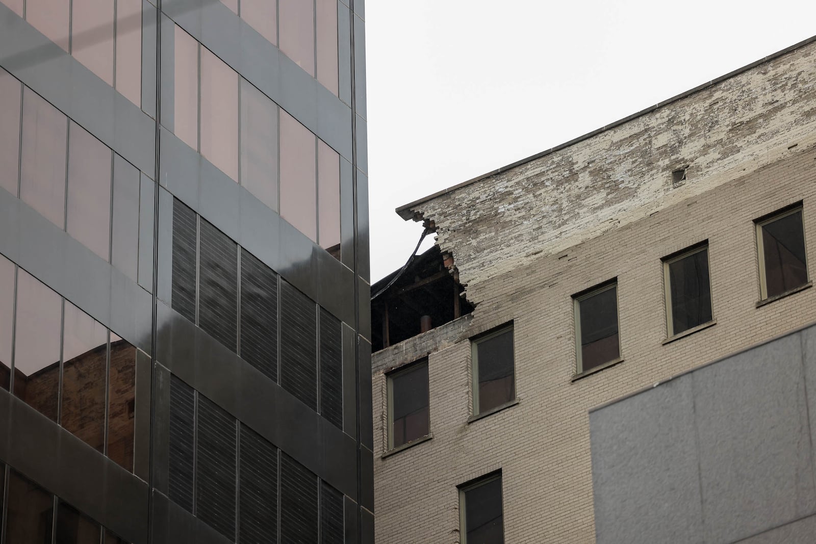 A view of the building formerly occupied by Key Bank at 34 N. Main St., which neighbors Stratacache Tower on Main Street. Part of the building's upper facade collapsed on Saturday afternoon, causing damage of Stratacache Tower. The Dayton Fire Department blocked off Main Street and also blocked off an alley between North Jefferson Street and Main Street. BRYANT BILLING/STAFF