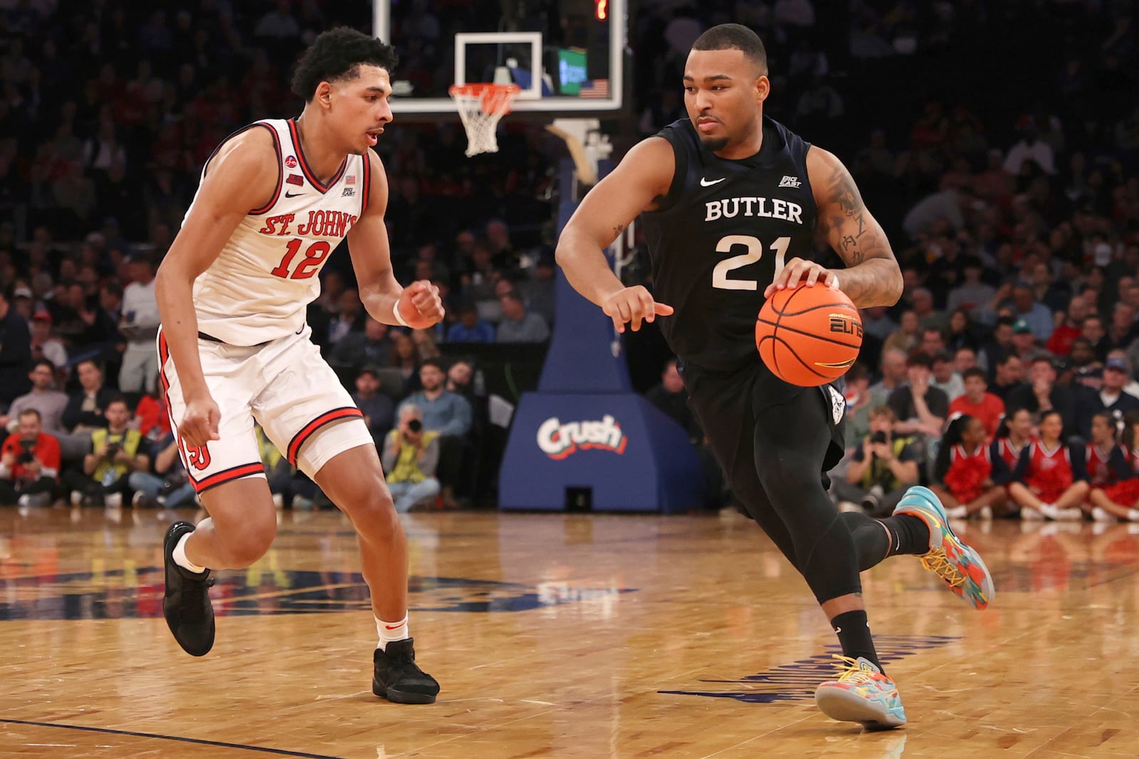 Butler forward Pierre Brooks II (21) dribbles against St. John's guard RJ Luis Jr. (12) during the second half of an NCAA college basketball game in the quarterfinals of the Big East Conference tournament, Thursday, March 13, 2025, in New York. (AP Photo/Pamela Smith)