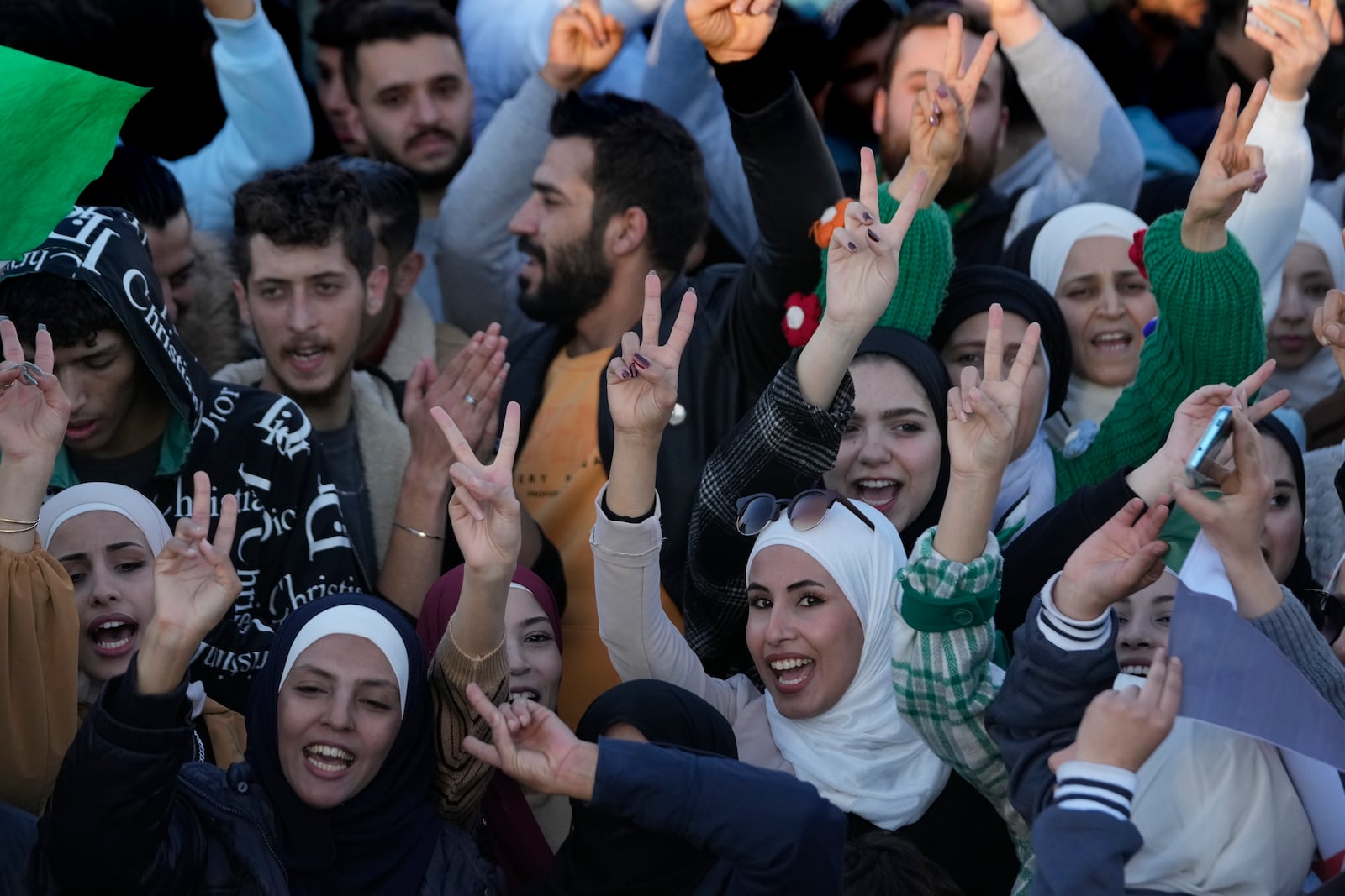 Syrians celebrate during a demonstration following the first Friday prayers since Bashar Assad's ouster, in Damascus' central square, Syria, on Friday, Dec. 13, 2024. (AP Photo/Hussein Malla)