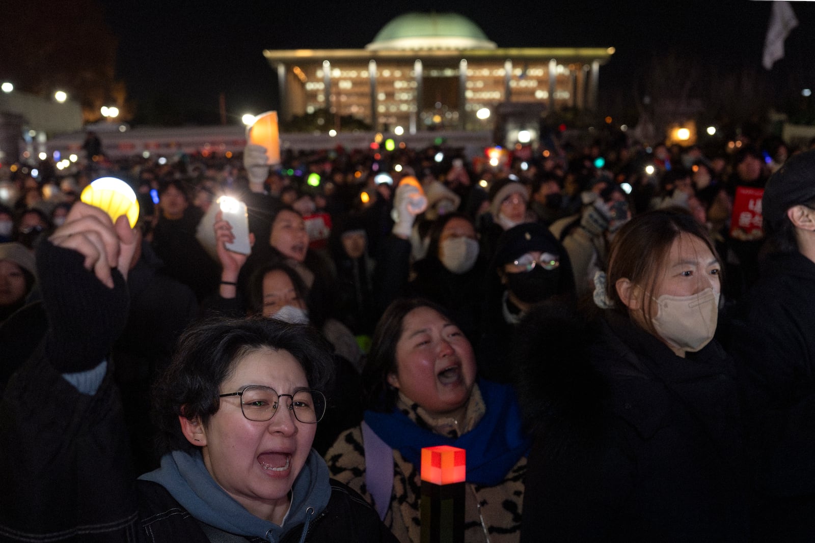 Protesters react outside the National Assembly after a failed impeachment of South Korean President Yoon Suk Yeol, following the President's short-lived martial law declaration in Seoul, South Korea, Saturday, Dec. 7, 2024. (AP Photo/Ng Han Guan)