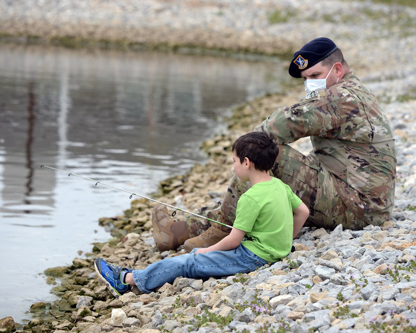 Tech. Sgt. Stephan Herrington, NCO in charge of resource protection for the 88th Security Forces Squadron, goes fishing with Prairies resident Elijah Frutiger during the “Coffee with a Cop” outreach at Wright-Patterson Air Force Base on April 9. U.S. AIR FORCE PHOTO/TY GREENLEES