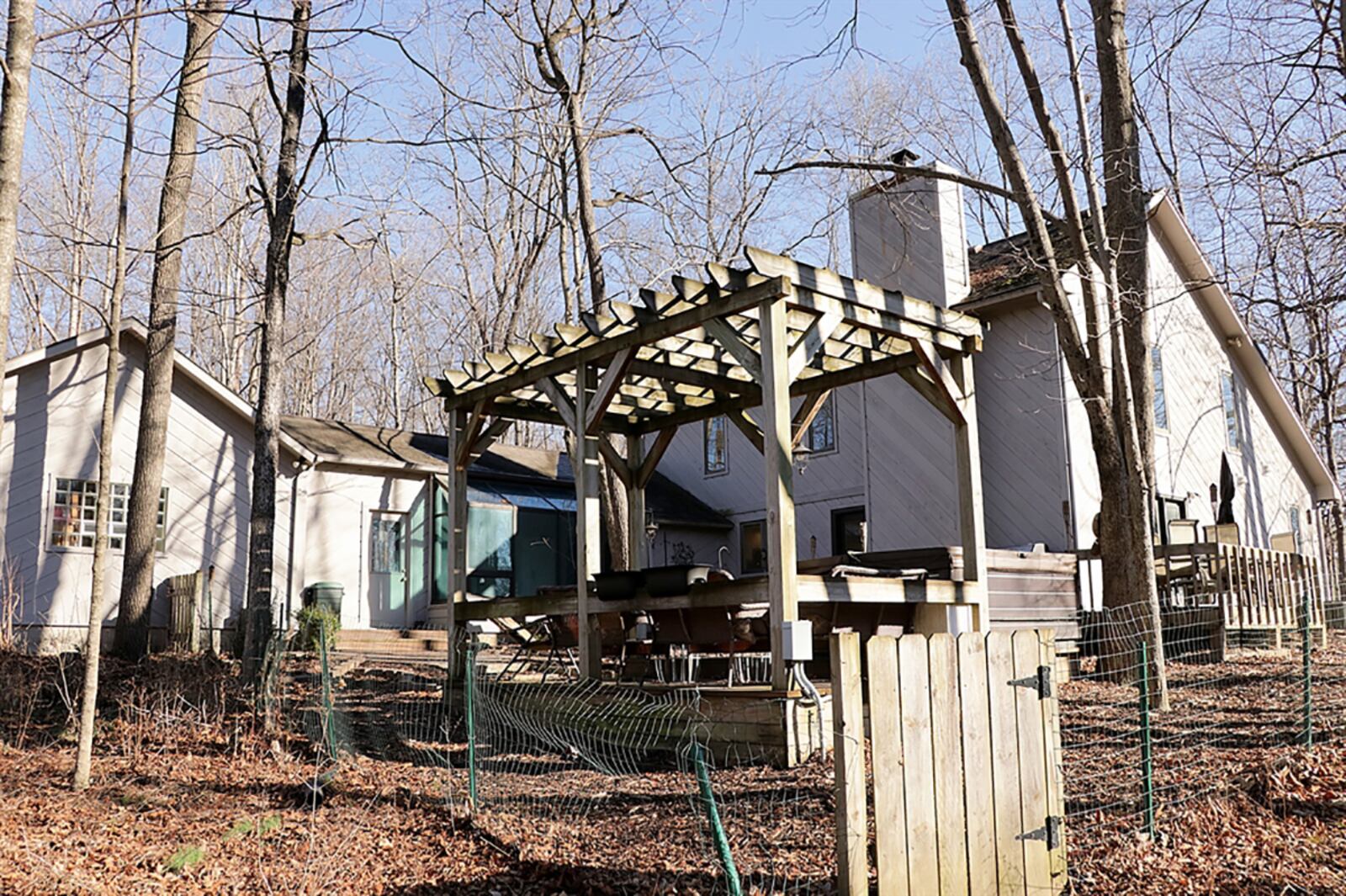 Accessible from two sets of glass doors from the great room, the backyard entertainment space includes a multi-level wooden deck with a hot tub platform and nearby pergola, paver-brick walkways and a covered porch off behind the garage. CONTRIBUTED PHOTO BY KATHY TYLER