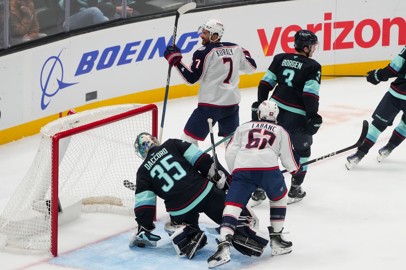 Columbus Blue Jackets center Sean Kuraly (7) reacts to scoring against Seattle Kraken goaltender Joey Daccord (35) as defenseman Will Borgen (3) looks away during the first period of an NHL hockey game Tuesday, Nov. 12, 2024, in Seattle. (AP Photo/Lindsey Wasson)