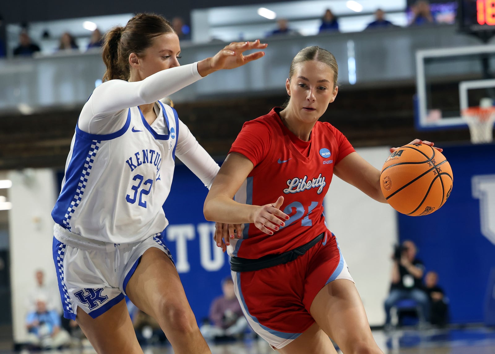 Liberty's Elisabeth Aegisdottir, left, drives while defended by Kentucky's Amelia Hassett (32) in the first round of the NCAA college basketball tournament in Lexington, Ky., Friday, March 21, 2025. (AP Photo/James Crisp)