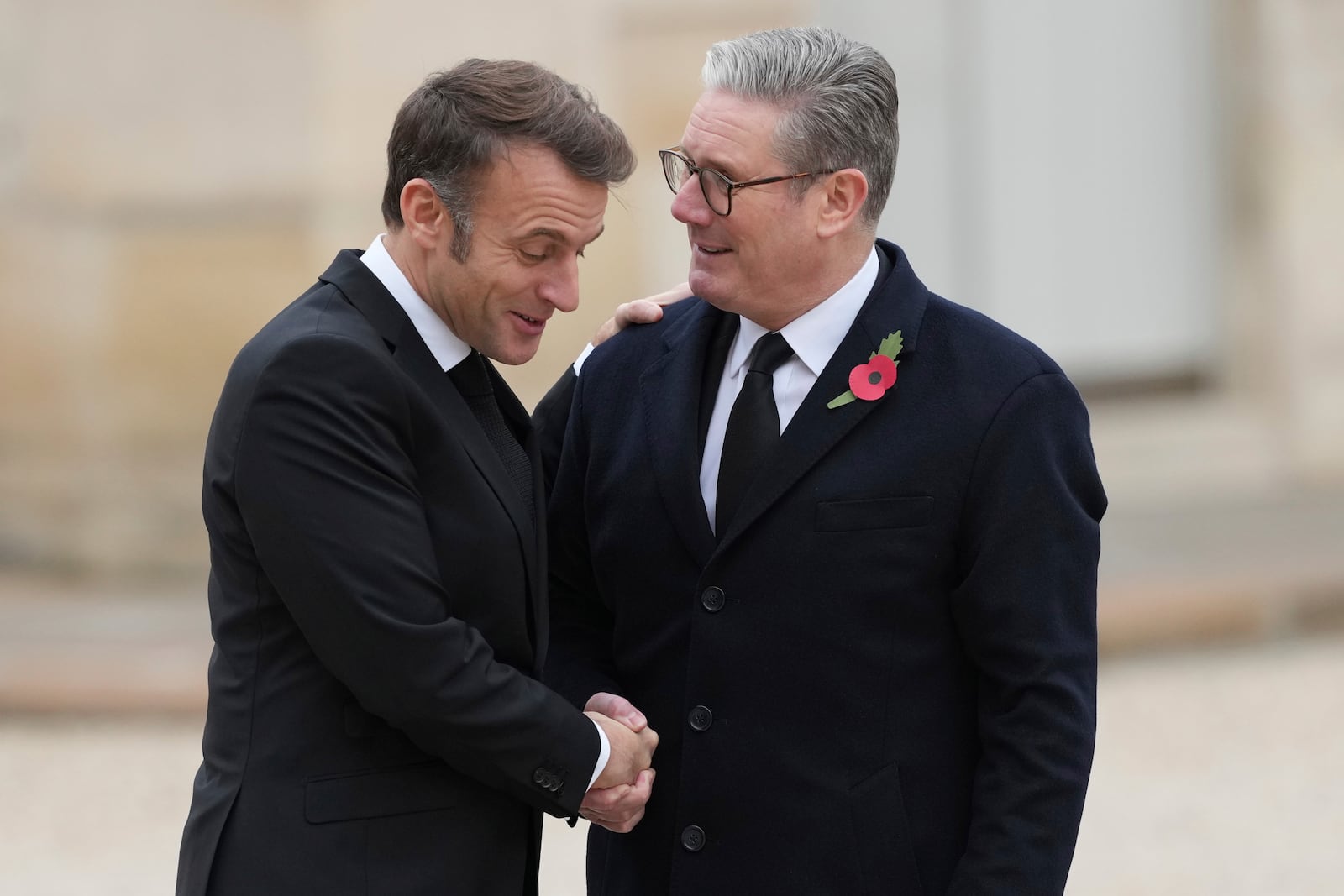 French President Emmanuel Macron, left, welcomes British Prime Minister Keir Starmer Monday, Nov. 11, 2024 at the Elysee Palace in Paris, before ceremonies marking the 106th anniversary of the Armistice, a celebration of their countries' friendship, as nations across the world pay tribute to their fallen soldiers in World War I. (AP Photo/Aurelien Morissard)