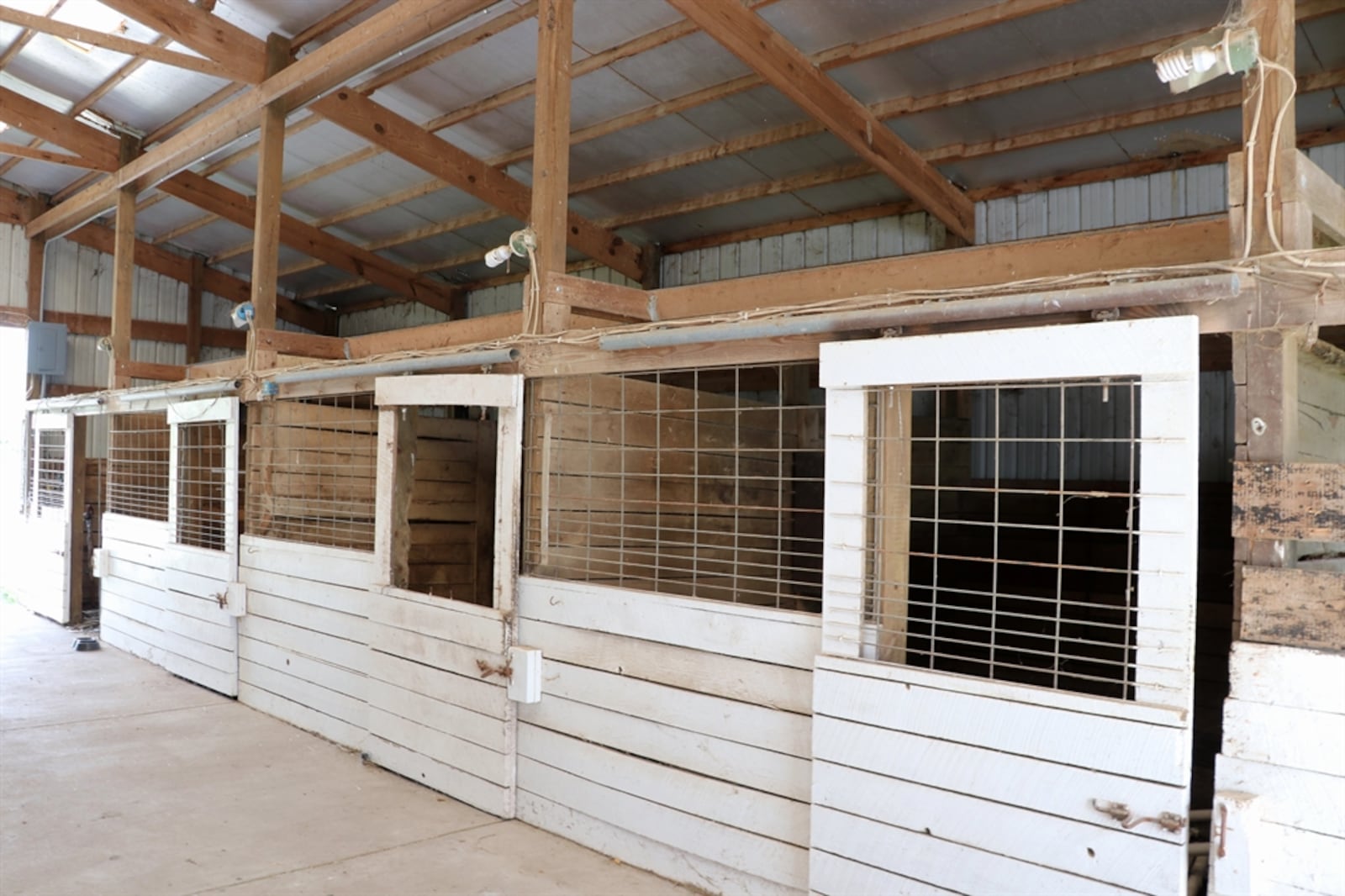 A 36-by-50-foot barn has 10 stalls with electric and water sources. Some of the fenced pastures are near the barns.