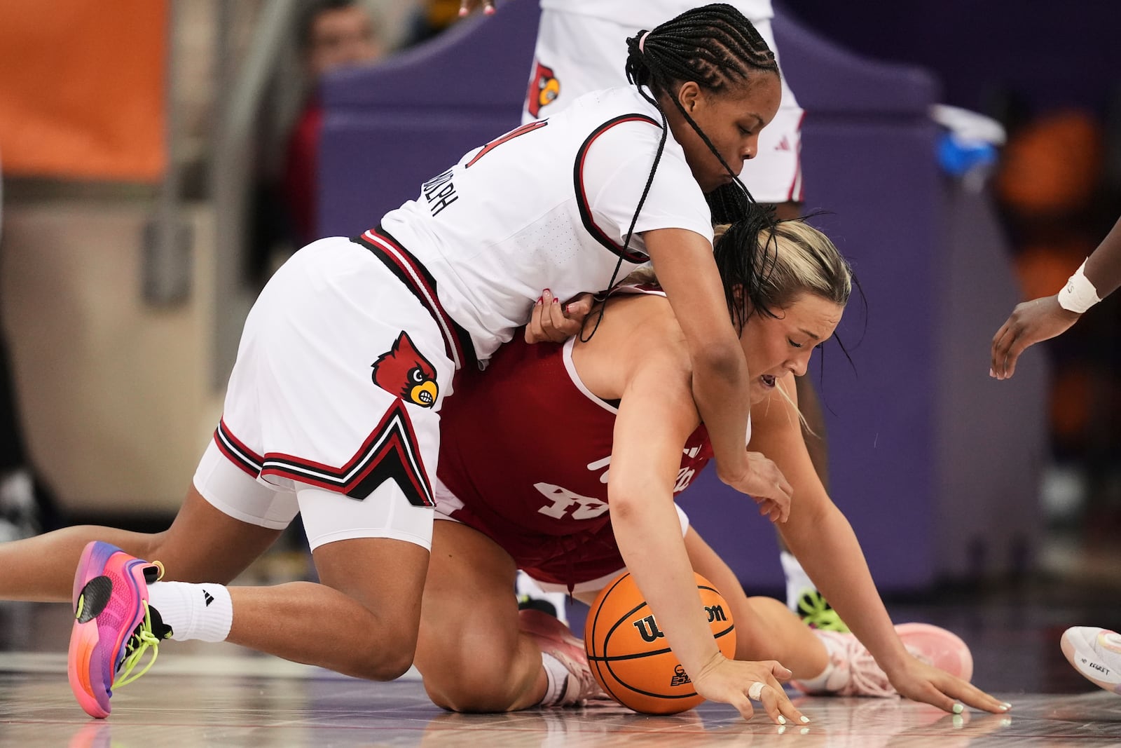 Louisville forward Mackenly Randolph, left, and Nebraska center Alexis Markowski, right, compete for a loose ball in the first half in the first round of the NCAA college basketball tournament in Fort Worth, Texas, Friday, March 21, 2025. (AP Photo/Tony Gutierrez)