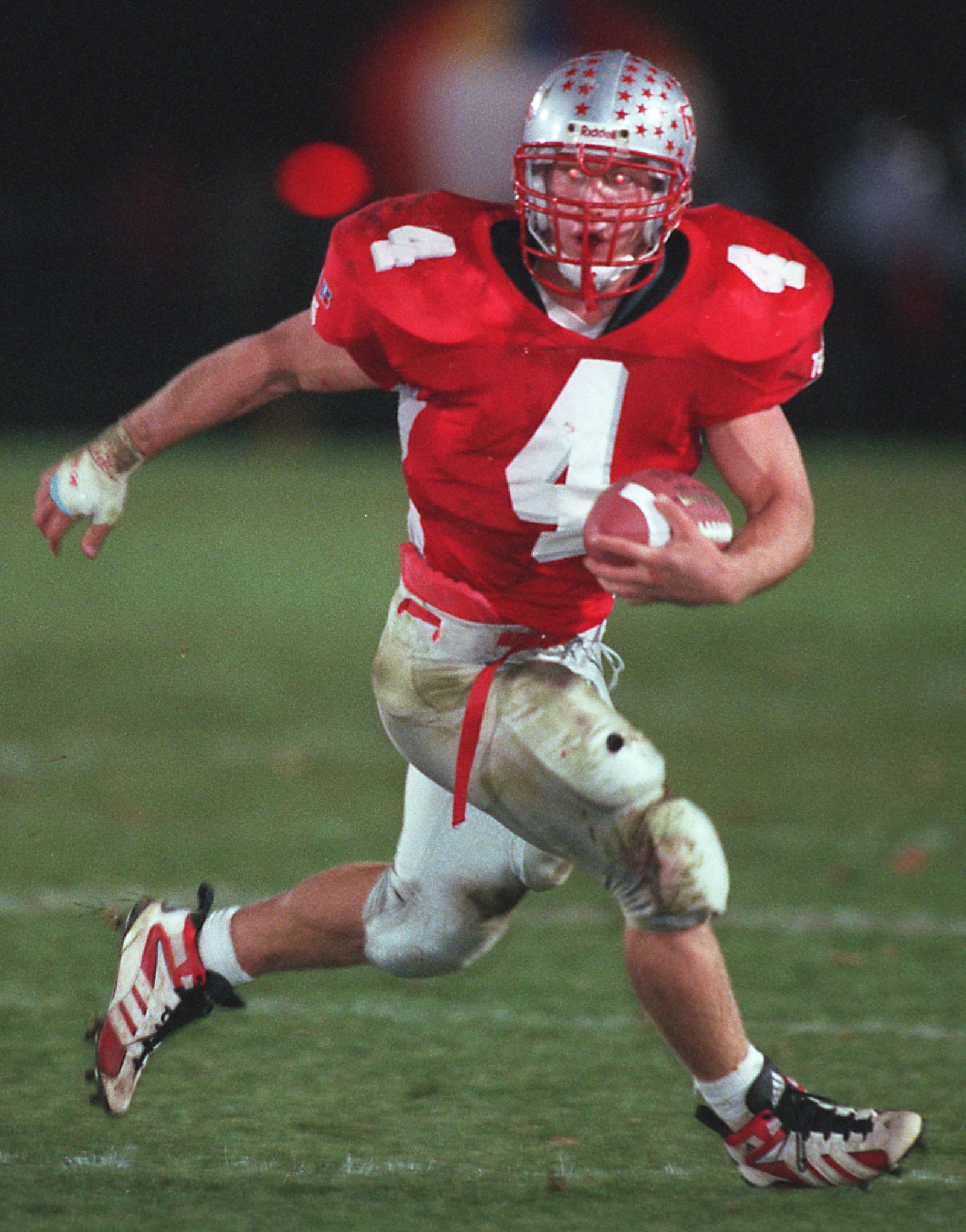 10/24/98; HIGH SCHOOL FOOTBALL -- Troy's Ryan Brewer (4) looks for room to run against Piqua on Oct. 24, 1998. DDN file