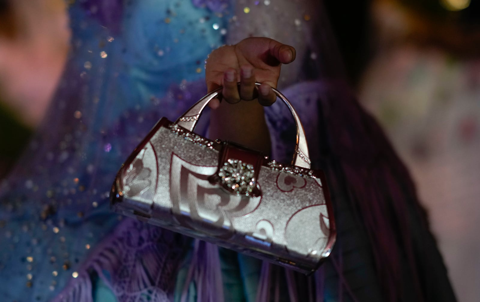 A woman models a creation by a local designer at a Chola fashion show, promoting the Andean style and beauty of Aymara women, in Viacha, Bolivia, Friday, Nov. 29, 2024. (AP Photo/Juan Karita)