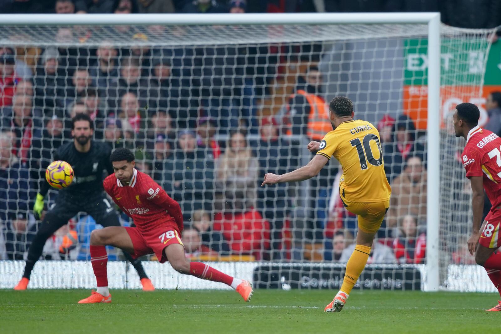 Wolverhampton Wanderers' Matheus Cunha, centre right, scores his side's opening goal during the English Premier League soccer match between Liverpool and Wolverhampton Wanderers at Anfield Stadium in Liverpool, Sunday, Feb. 16, 2025. (AP Photo/Ian Hodgson)