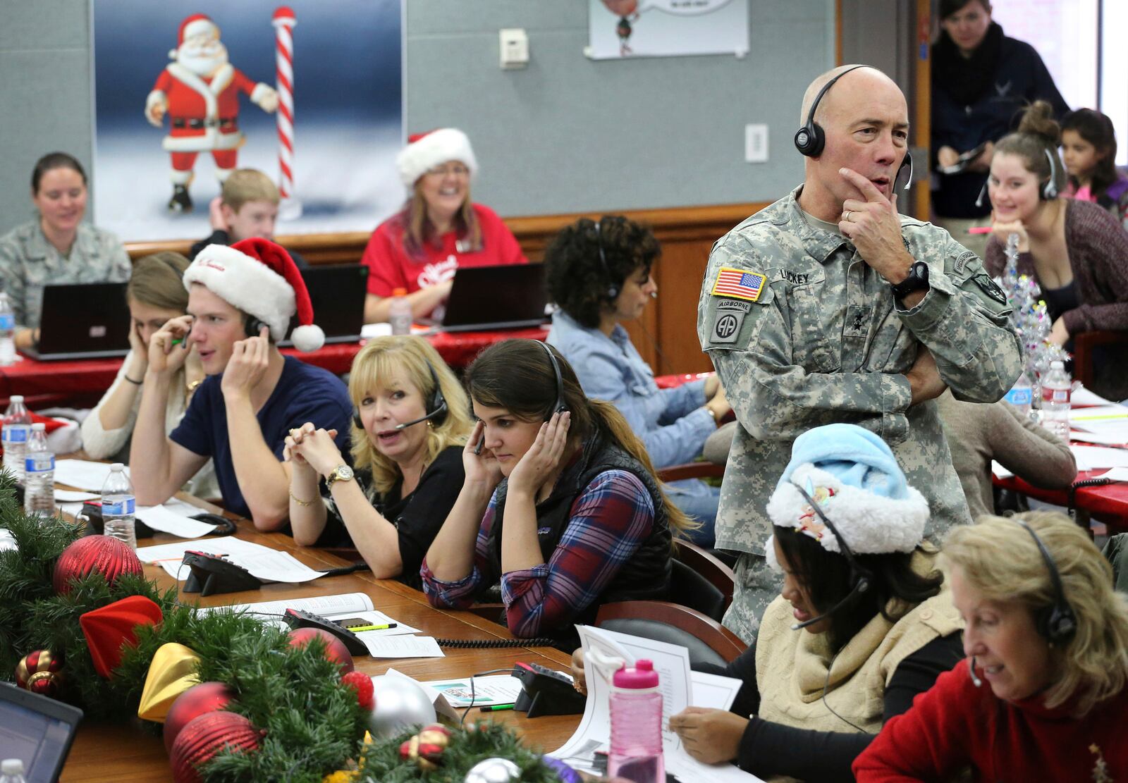 FILE - NORAD Chief of Staff Maj. Gen. Charles D. Luckey takes a call while volunteering at the NORAD Tracks Santa center at Peterson Air Force Base in Colorado Springs, Colo., Dec. 24, 2014. (AP Photo/Brennan Linsley, File)