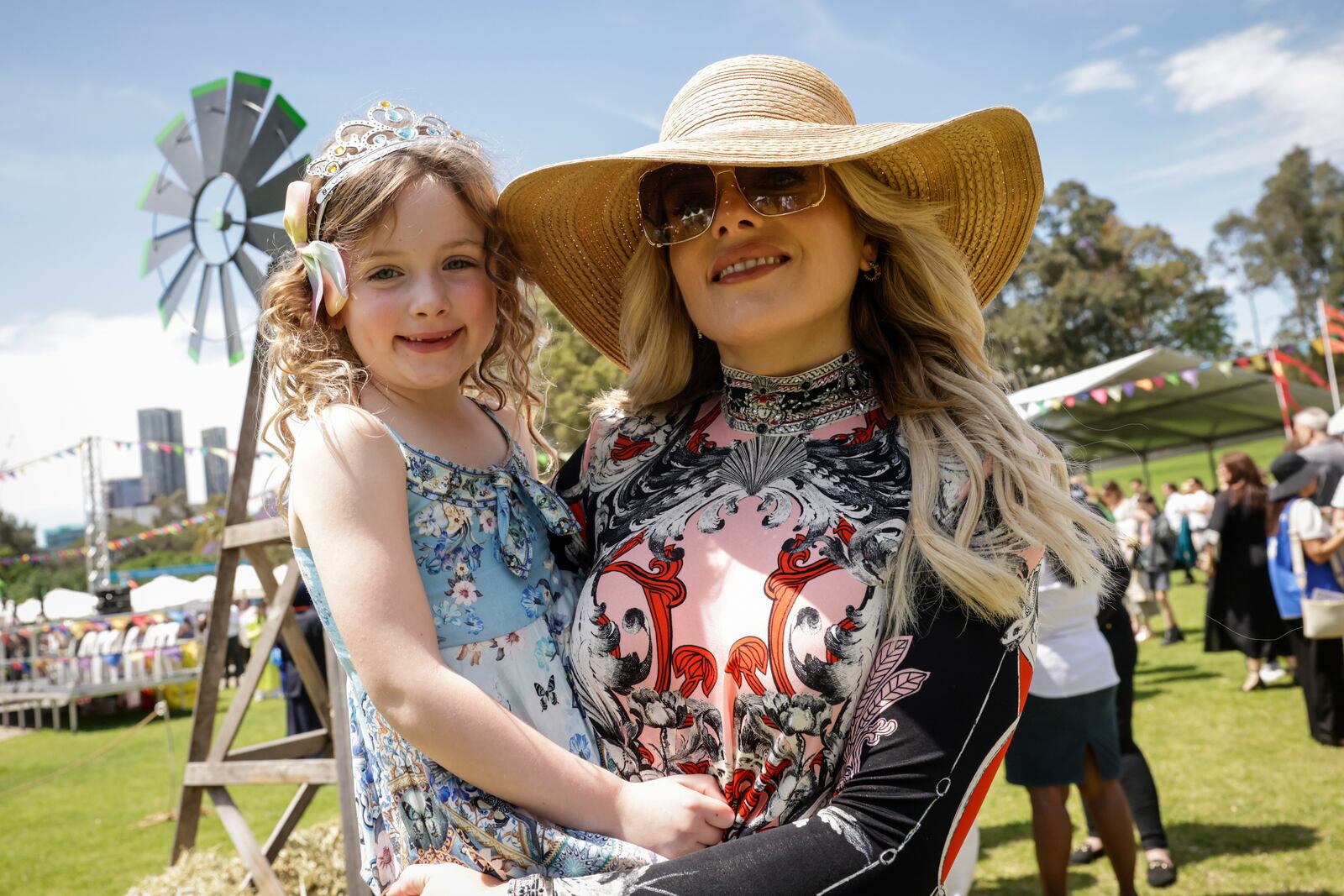 Members of the public wait for Britain's King Charles III and Queen Camilla to arrive to attend the Premier's Community BBQ on Tuesday Oct. 22, 2024 in Sydney, Australia. (Brook Mitchell/Pool Photo via AP)