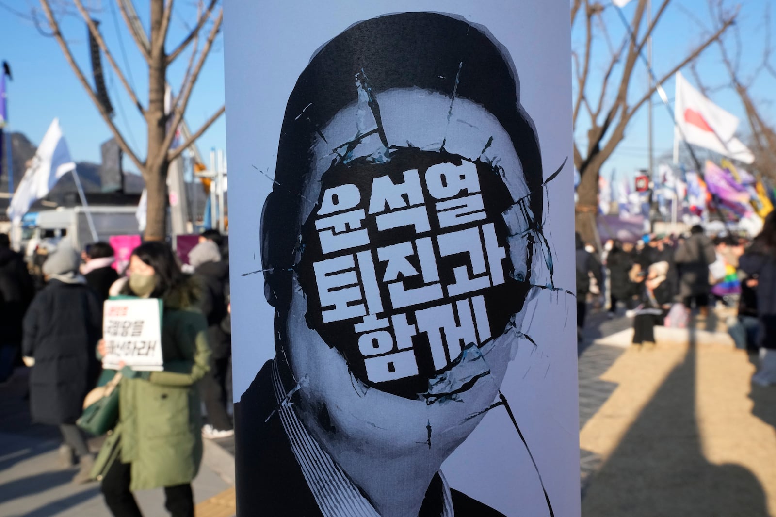 A banner showing an image of impeached South Korean President Yoon Suk Yeol with the words "With Yoon Suk Yeol's resignation", is displayed at a rally demanding his arrest in Seoul, South Korea, Saturday, Jan. 11, 2025. (AP Photo/Ahn Young-joon)