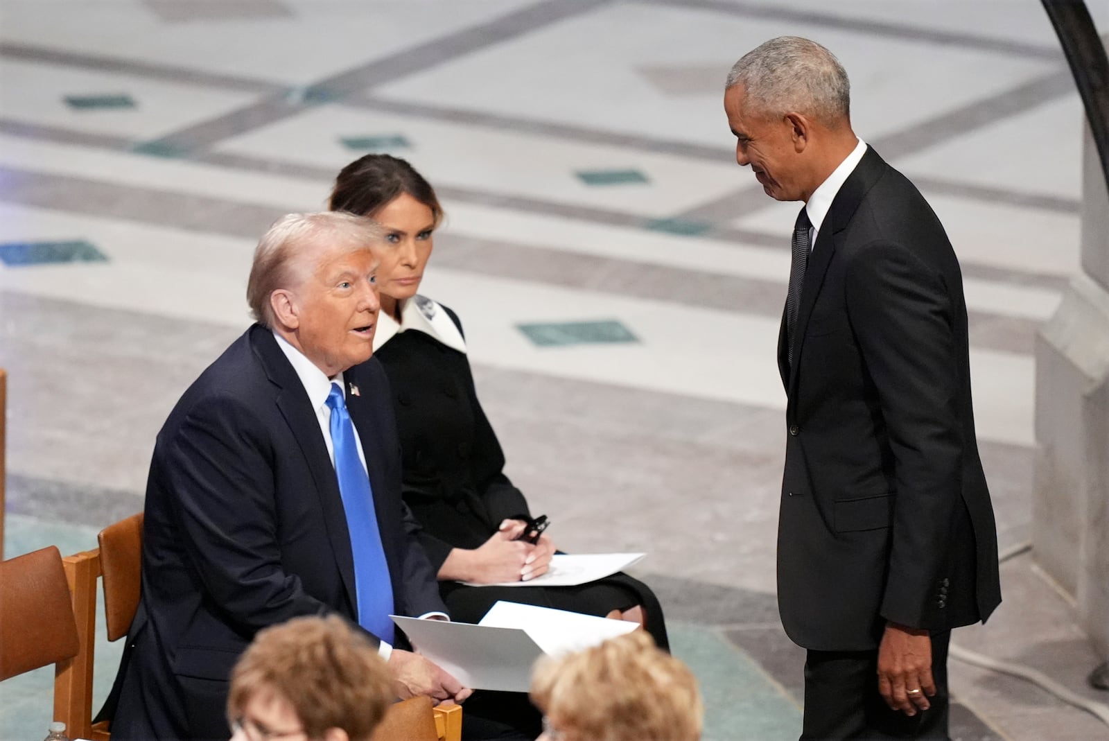 President-elect Donald Trump and Melania Trump watch as former President Barack Obama arrives before the state funeral for former President Jimmy Carter at Washington National Cathedral in Washington, Thursday, Jan. 9, 2025. (AP Photo/Jacquelyn Martin)