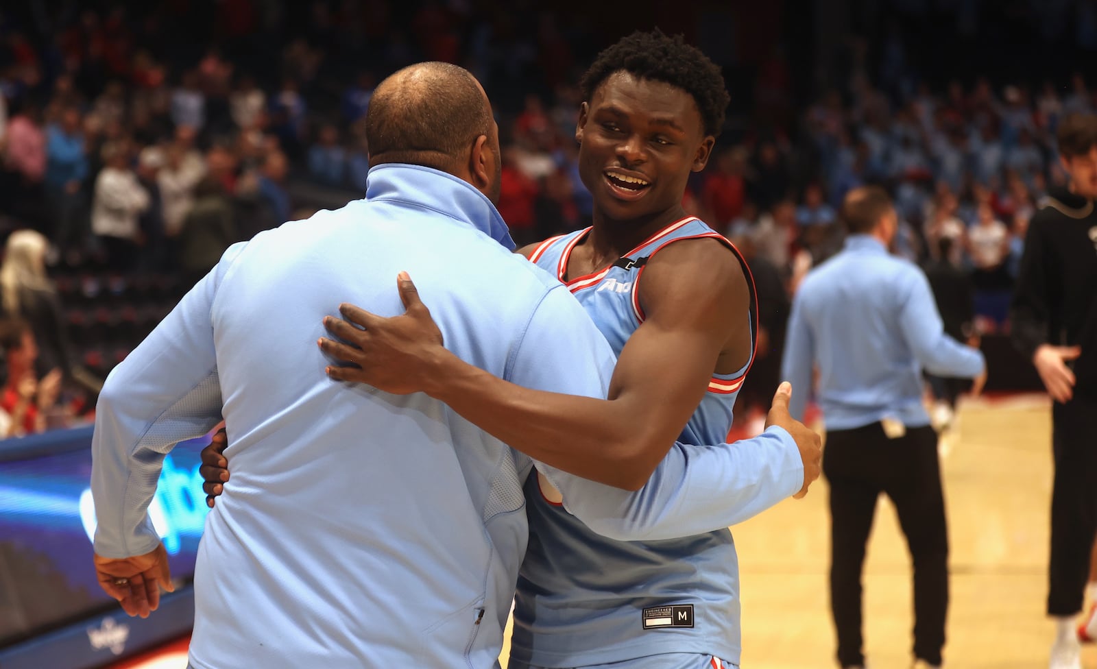 Dayton's Enoch Cheeks hugs Jeremaine Henderson after a victory against Saint Louis on Tuesday, March 4, 2025, at UD Arena. David Jablonski/Staff